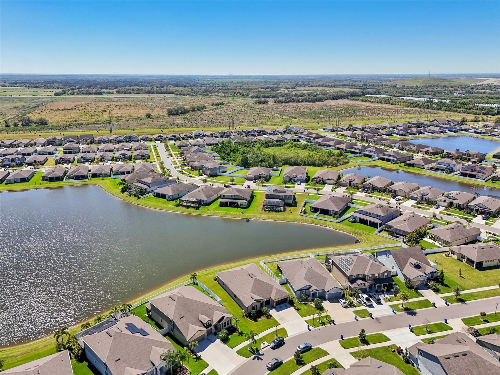 NO BACK YARD NEIGHBORS! AERIAL VIEW OF LARGE POND BEHIND PROPERTY