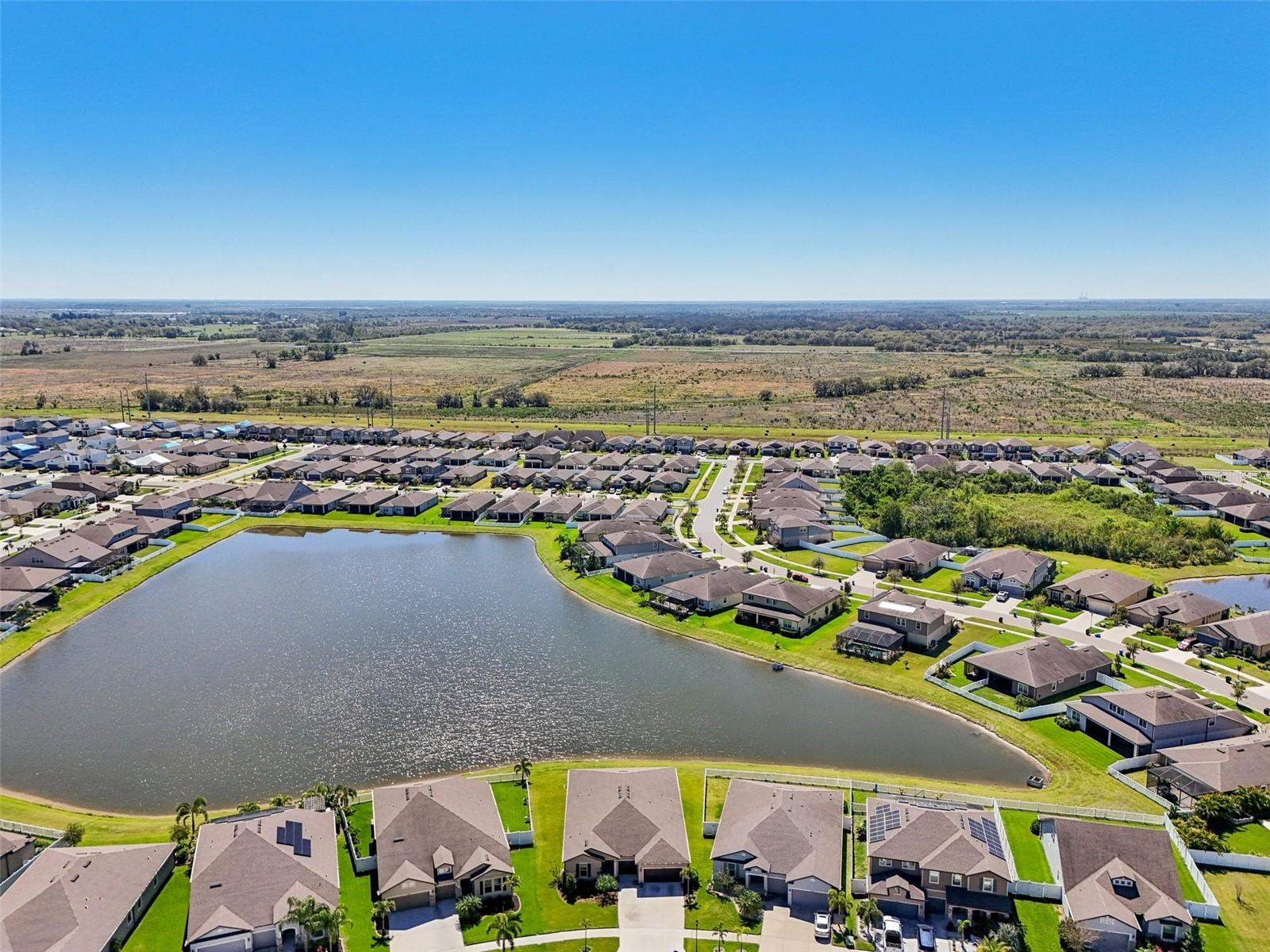 NO BACK YARD NEIGHBORS! AERIAL VIEW OF LARGE POND BEHIND PROPERTY