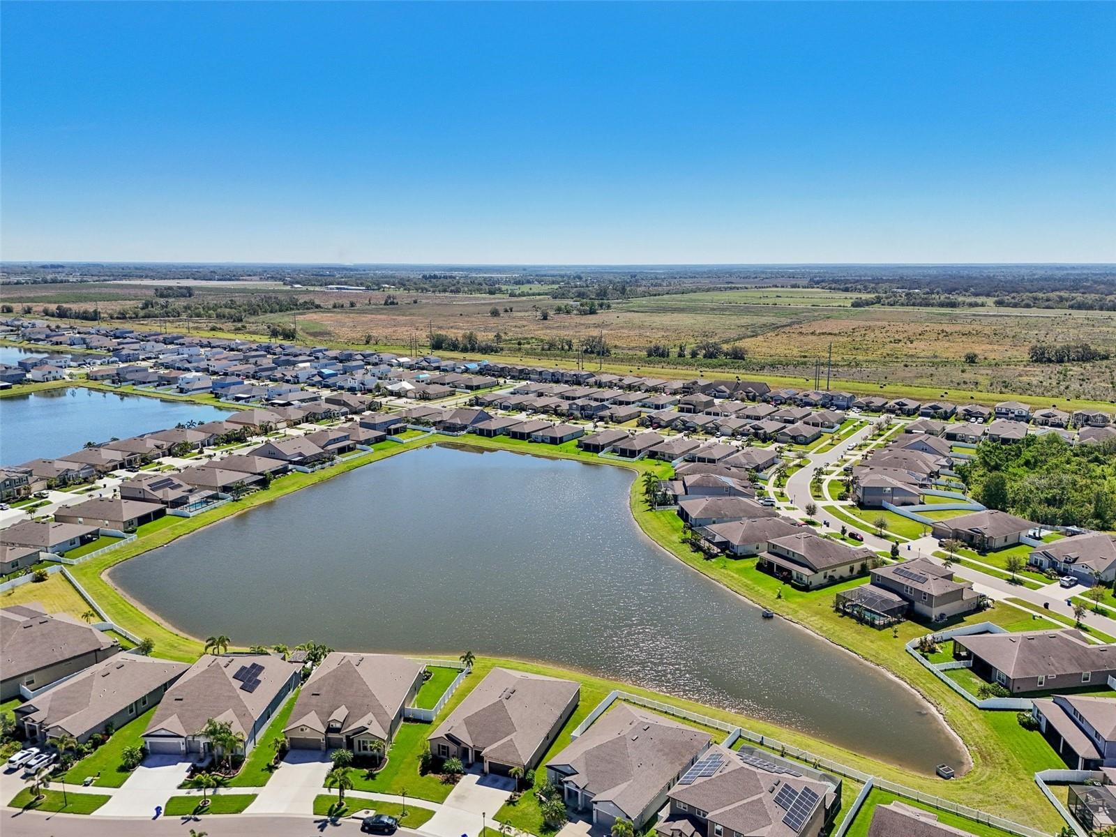 NO BACK YARD NEIGHBORS! AERIAL VIEW OF LARGE POND BEHIND PROPERTY