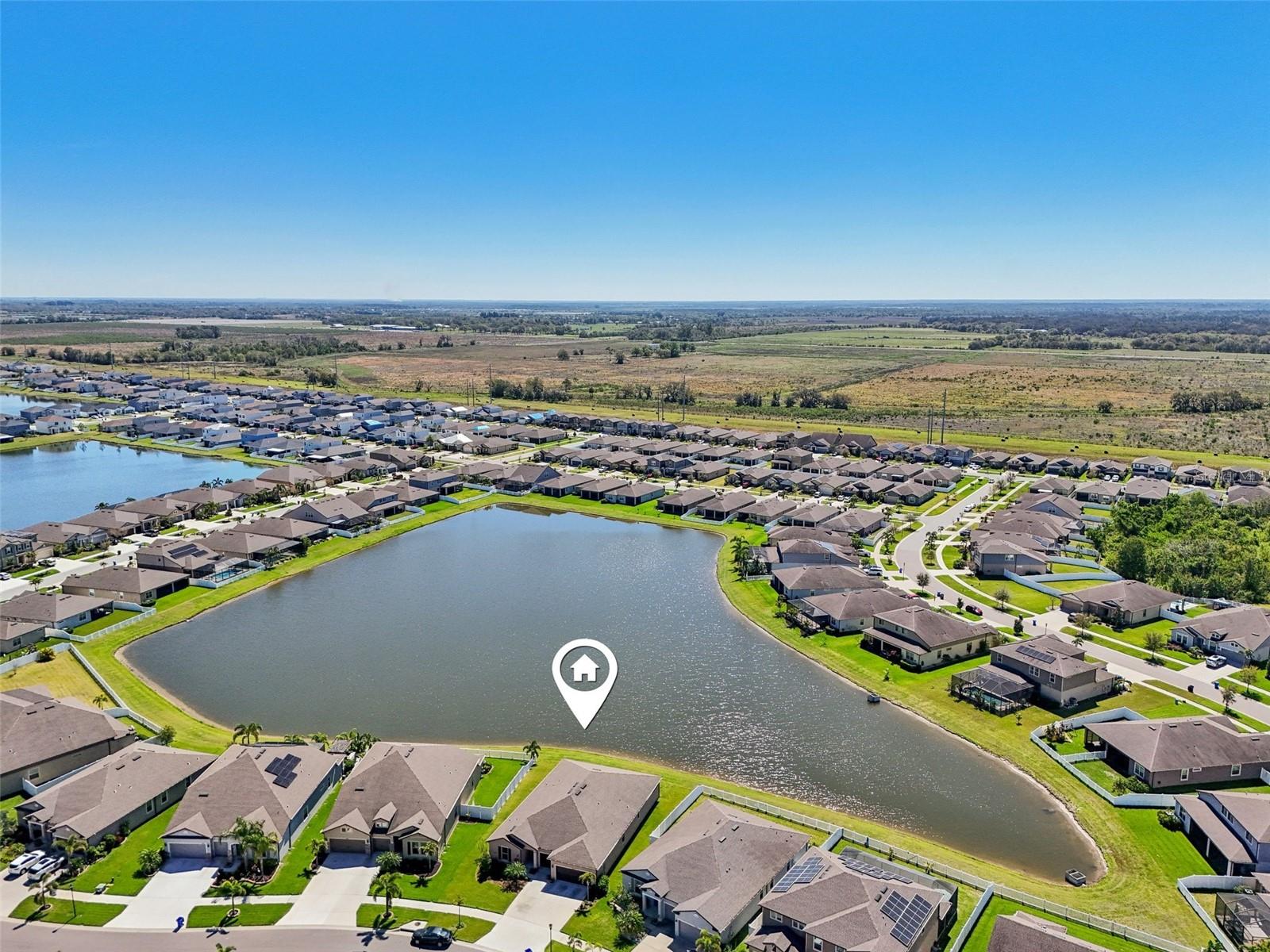 NO BACK YARD NEIGHBORS! AERIAL VIEW OF LARGE POND BEHIND PROPERTY