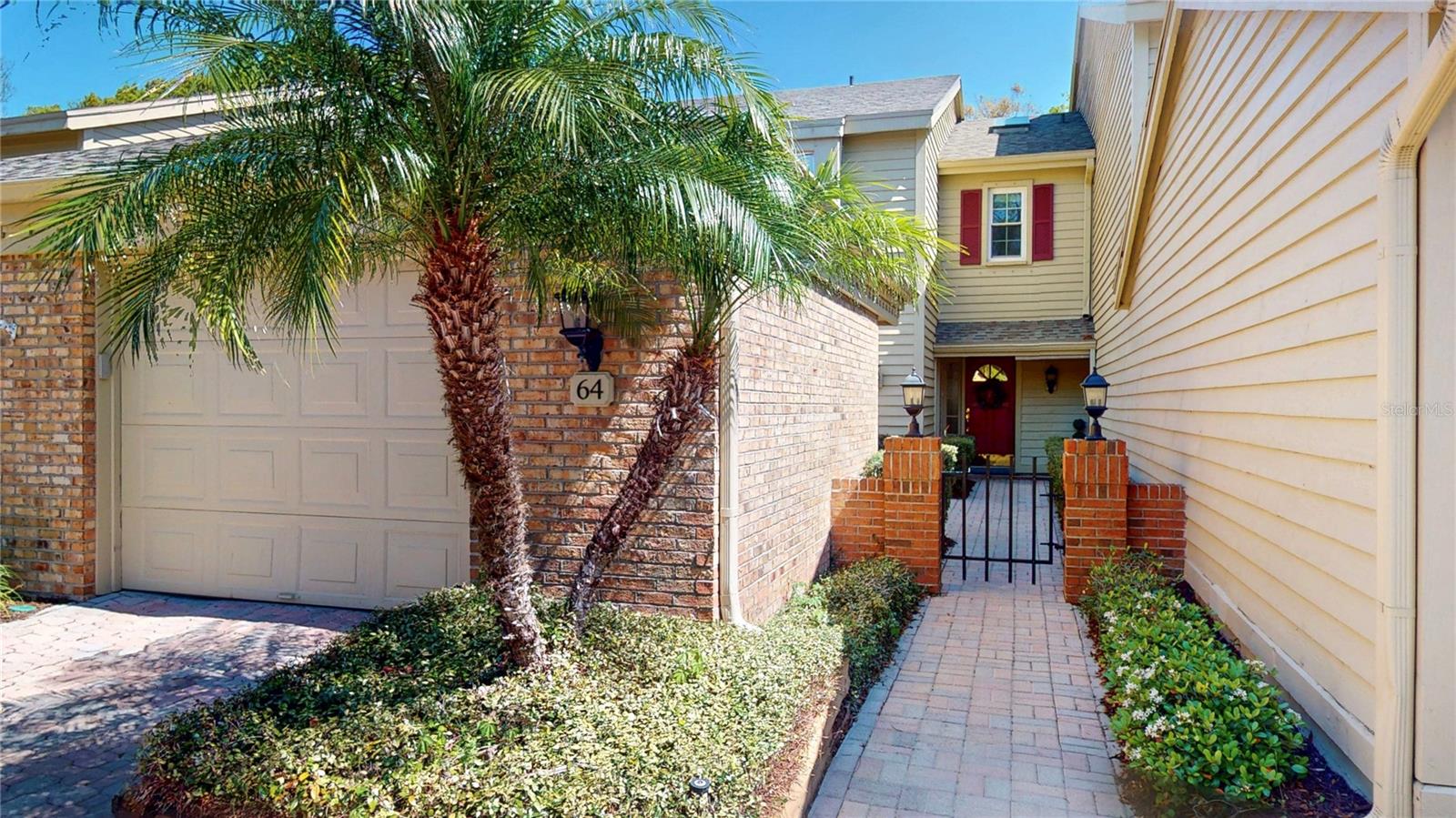 Garage and brick-lined walkway to the front entrance.