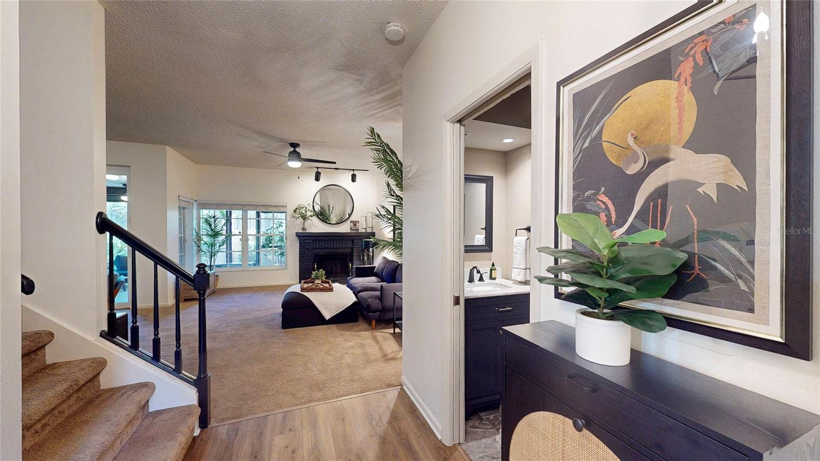 Living room, stairs to the 2nd floor, and guest powder room on the first floor - viewed from the front foyer.