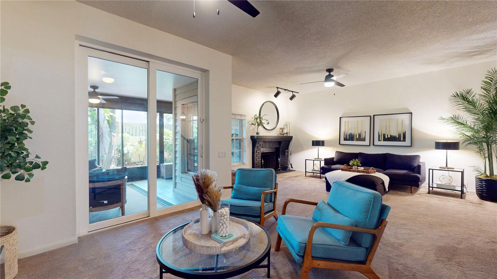 From dining room area by kitchen, looking toward living room with fireplace.  Sliders to the enclosed patio next to the dining room.