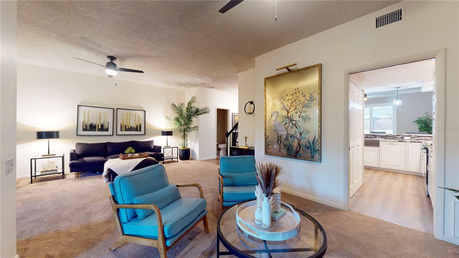 From the back corner of the dining room area looking toward the living room and the kitchen.