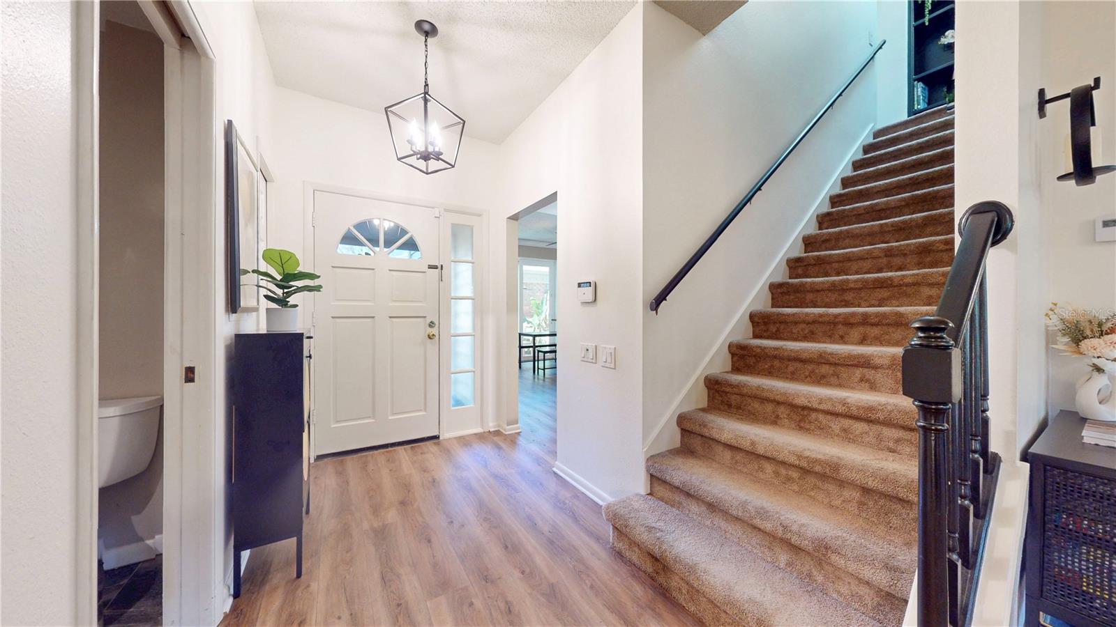 Front foyer area with entrance to the kitchen, guest powder room, stairs to the 2nd floor.