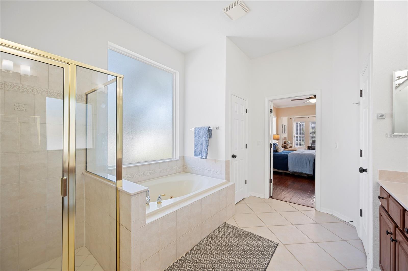 Owner's bath with walk in shower and garden tub