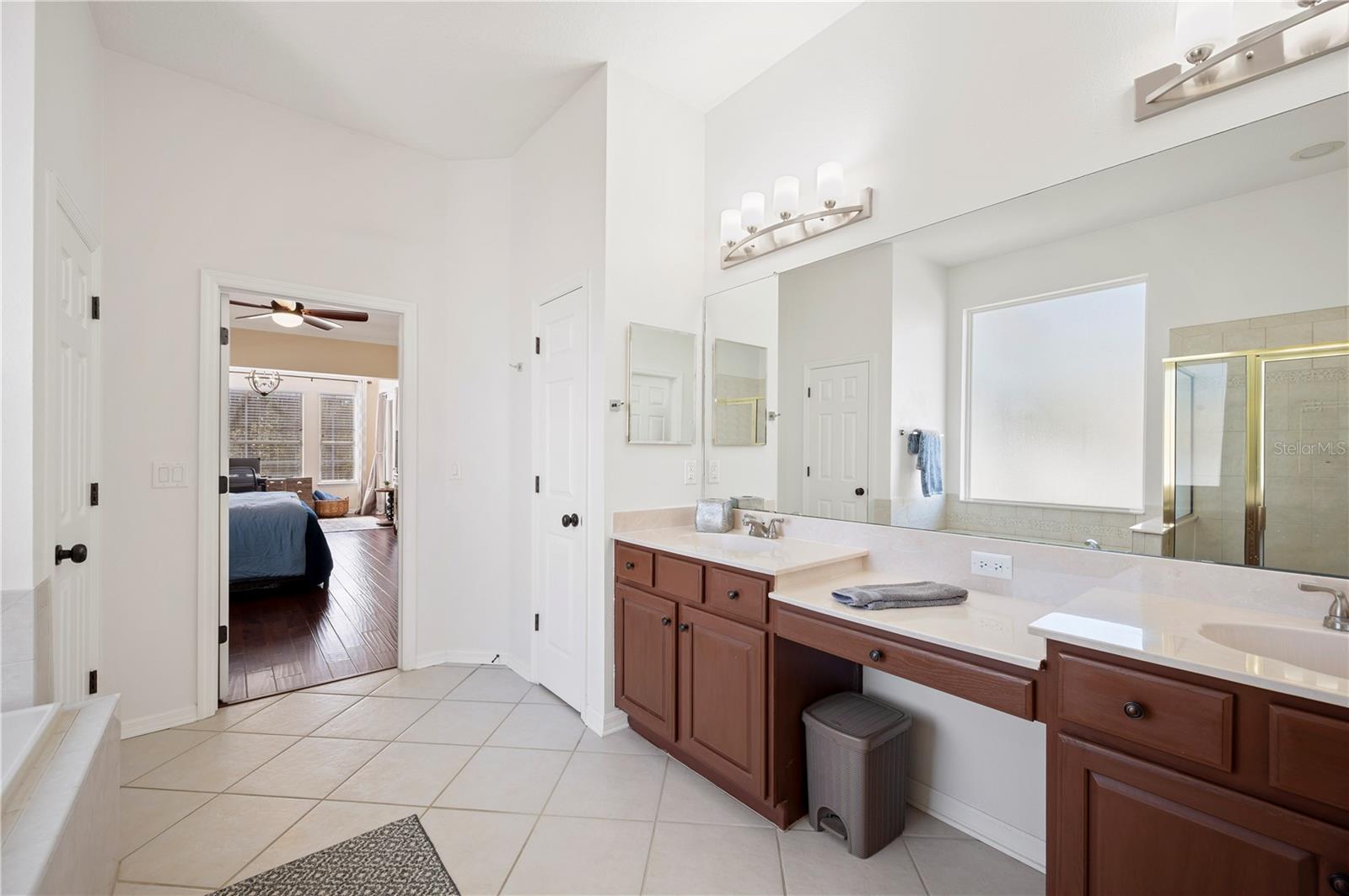 Owner's bath with double vanity and makeup area.