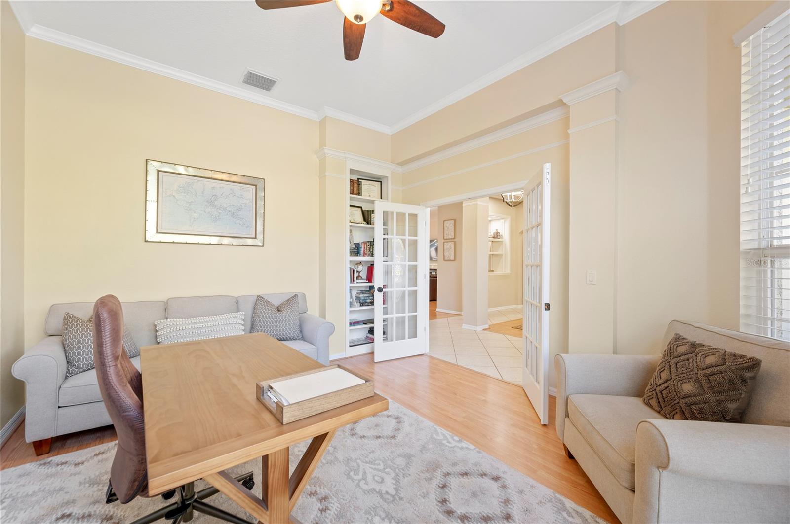 Office with French doors and built in shelving