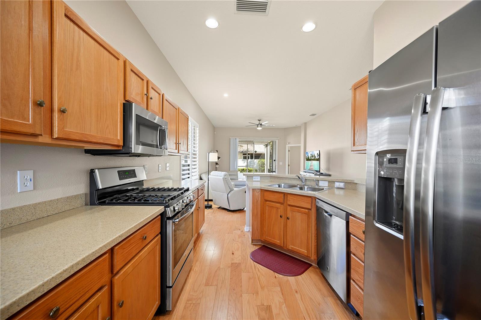 Oak cabinets with corian counter tops and stainless appliances.