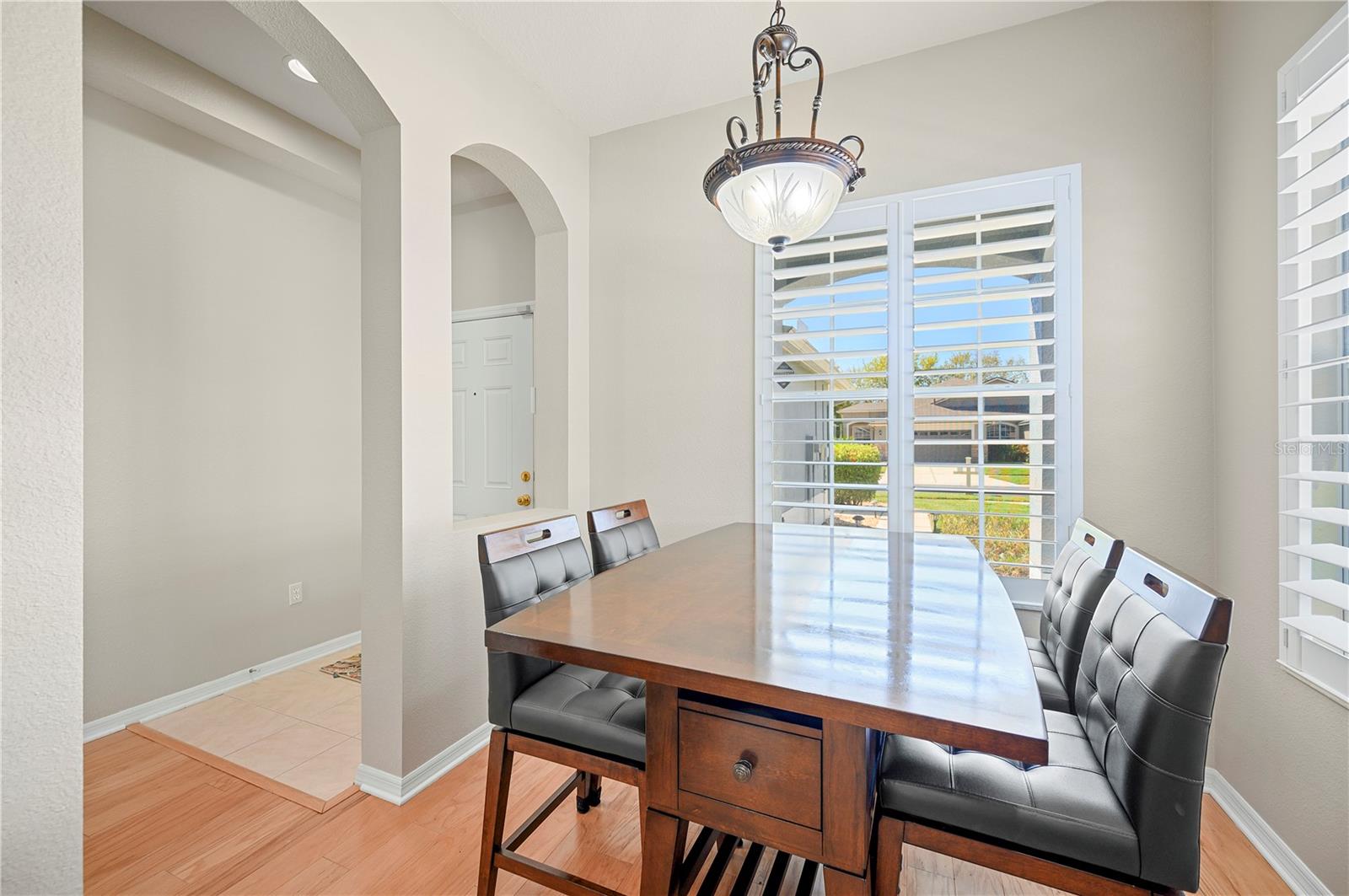 Dining room with lots of windows and shutters