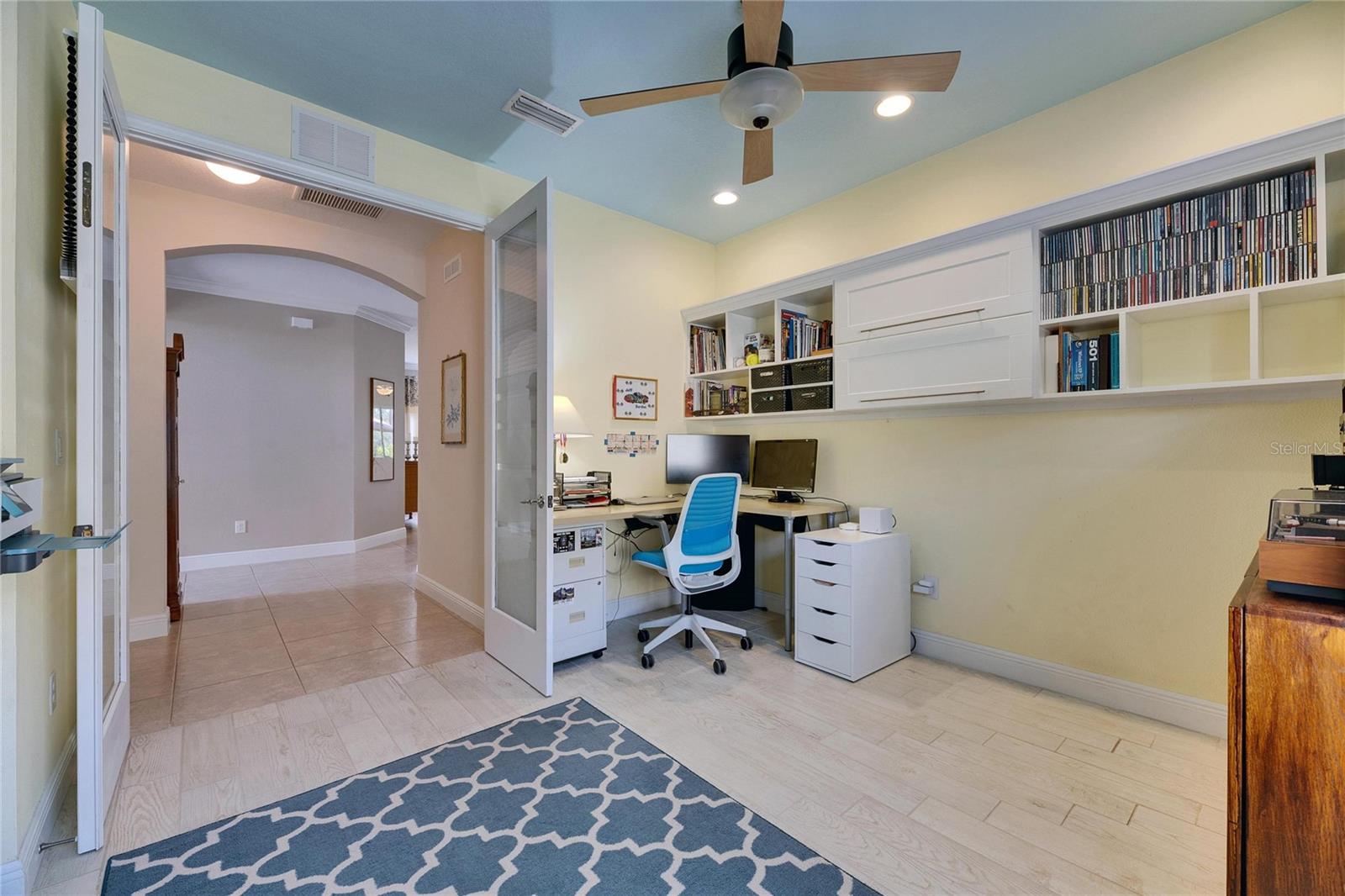 Inside the office with glass doors looking toward the hallway.