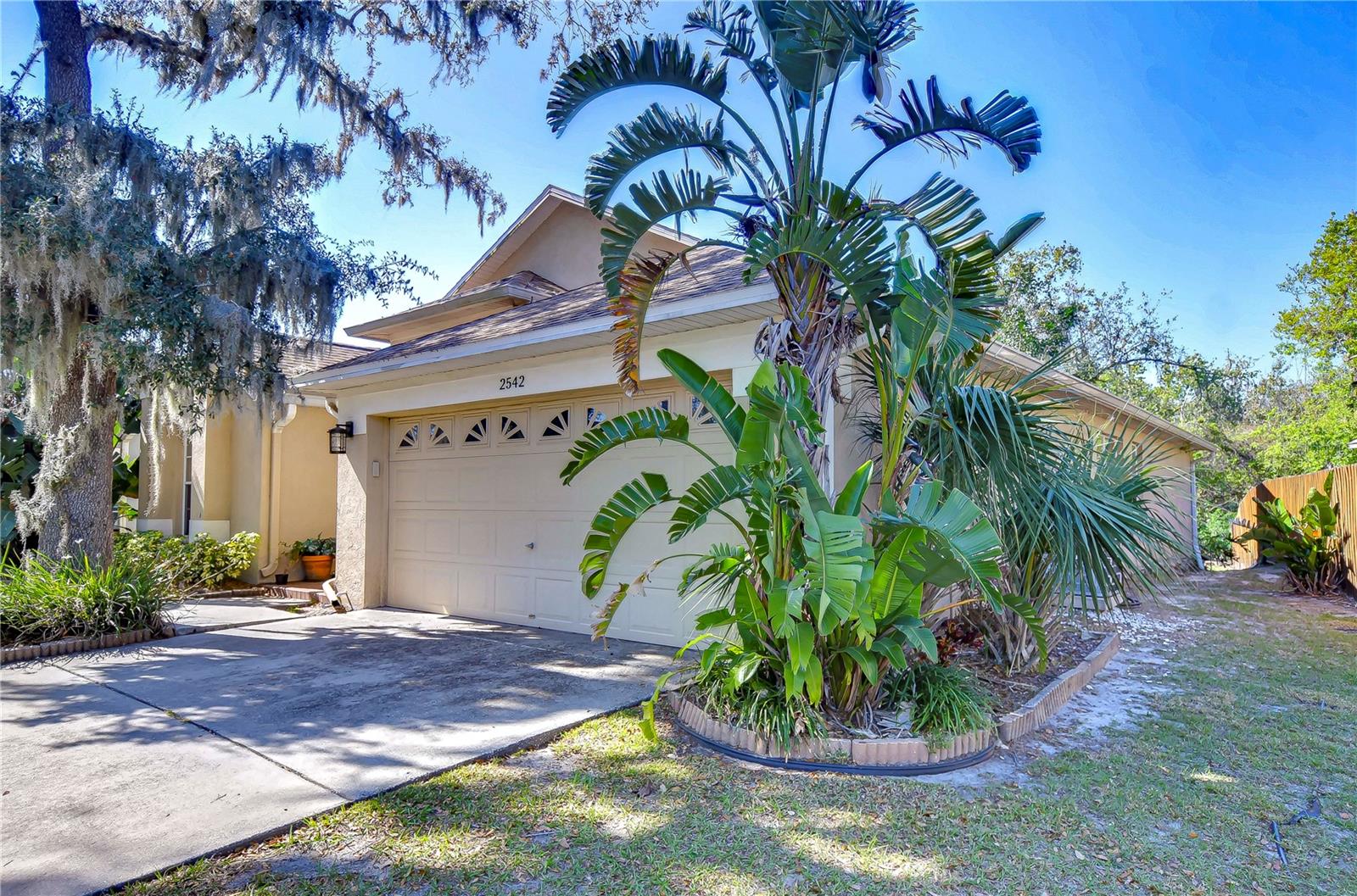 Nestled amidst lush greenery, this charming four-bedroom home offers a serene retreat with a touch of tropical flair.