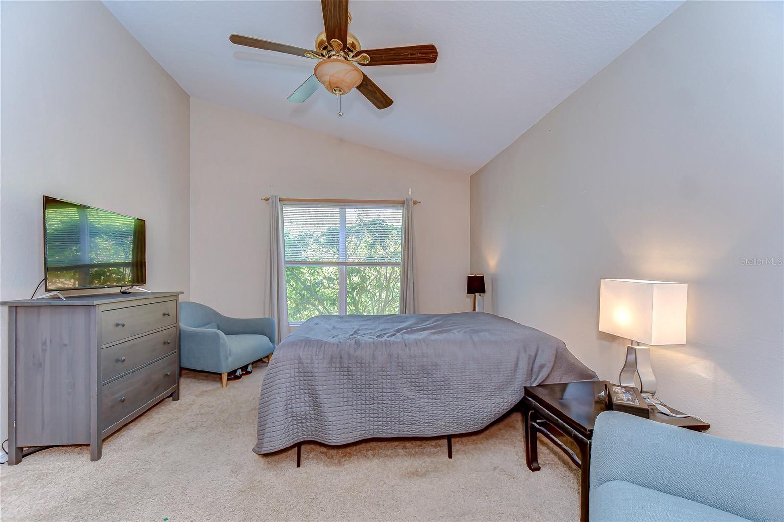 Discover the comfort of this charming primary bedroom, boasting ample natural light that pours through the large window, creating a warm and inviting oasis.