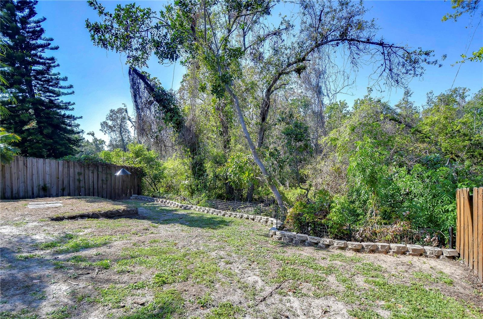 Surrounded by lush greenery, this serene outdoor space is perfect for weekend barbecues or simply enjoying the Florida sun.