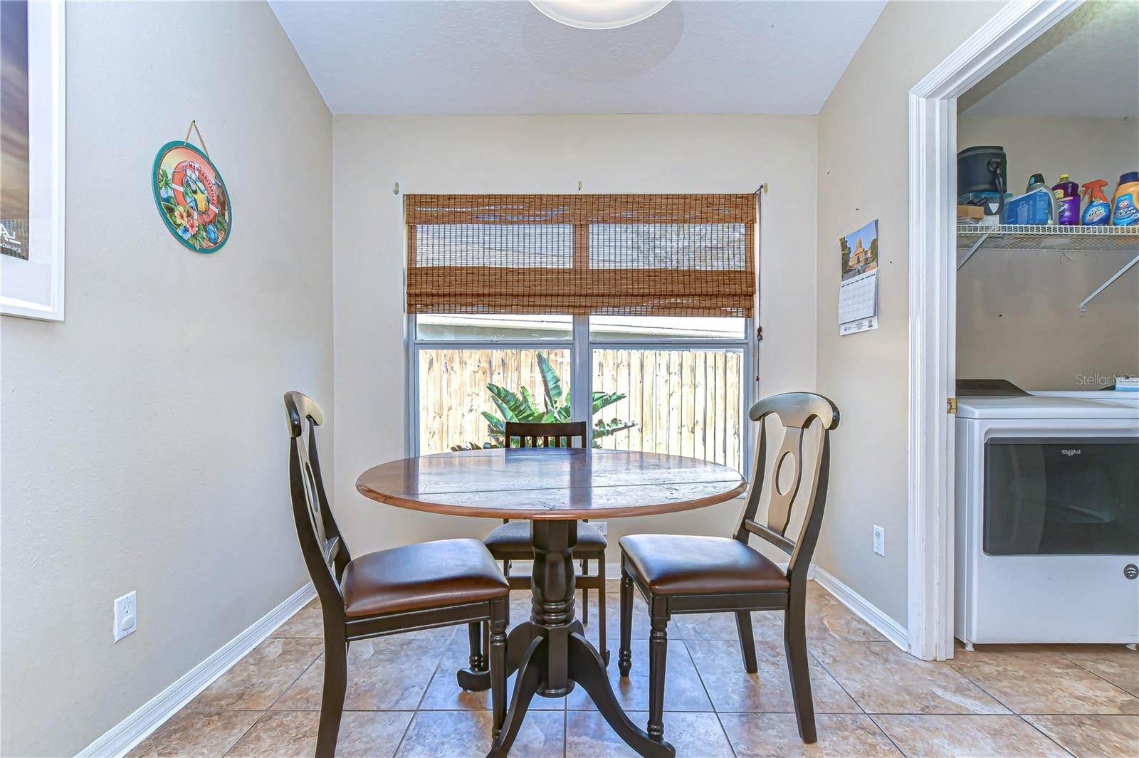 The sunlit dining area offers the perfect spot for meals with a garden view. A