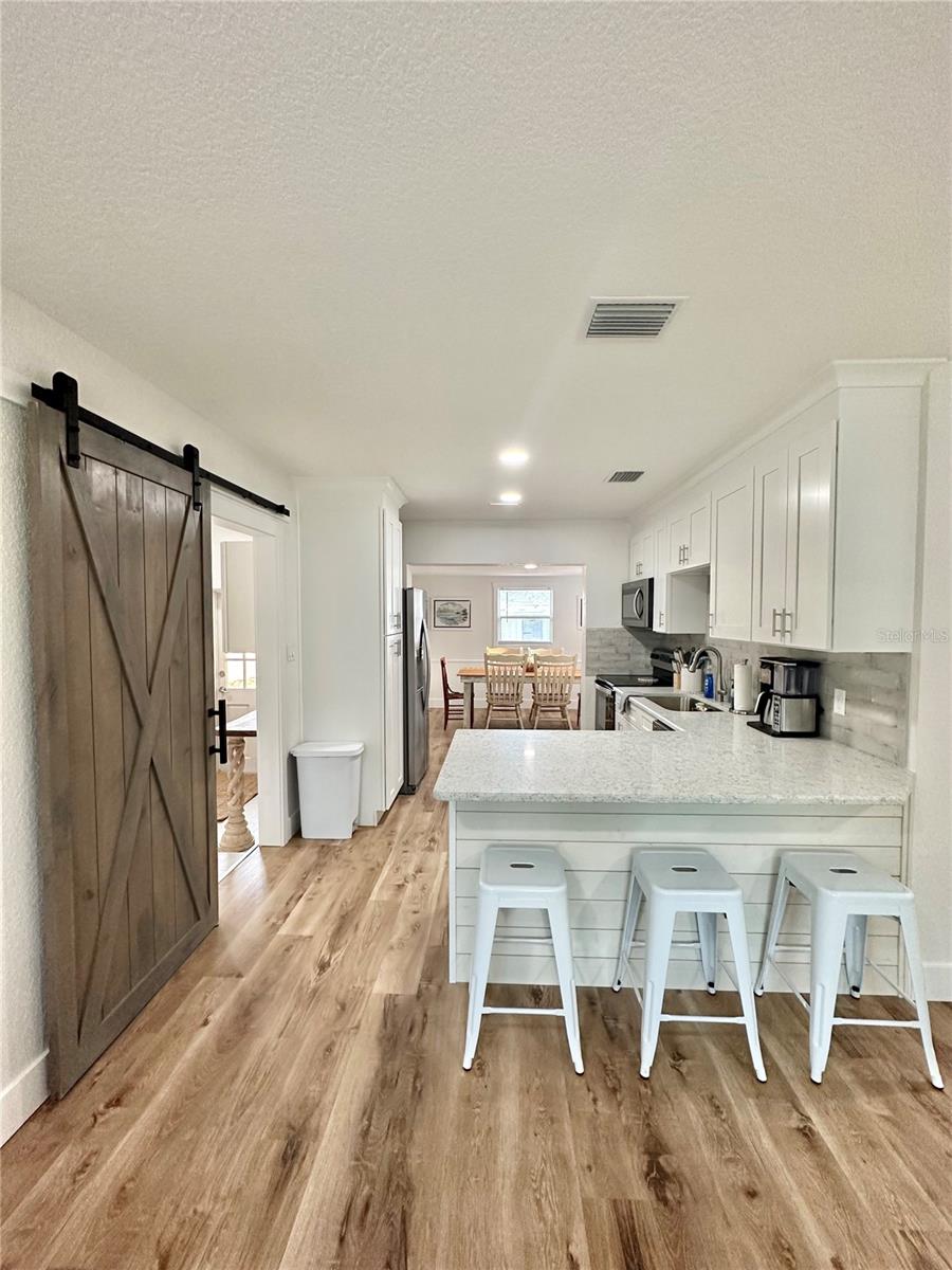 Kitchen peninsula with bar stool seating (FRONT HOUSE)