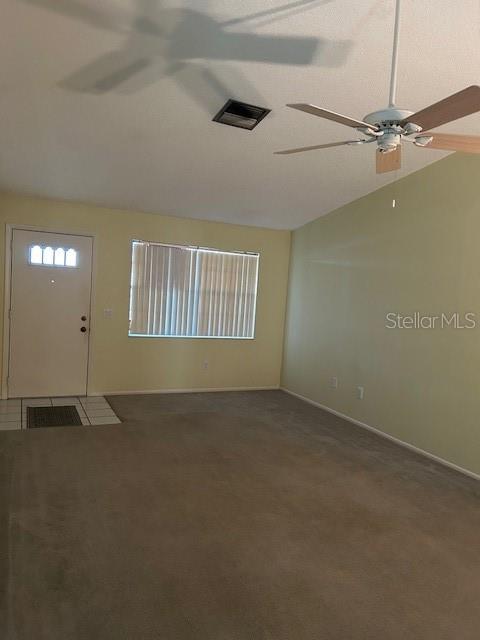 Living room with vaulted ceiling.