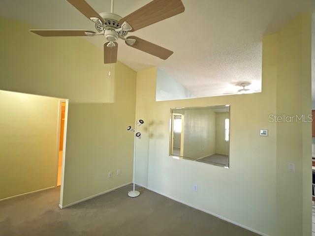 Dining room with vaulted ceiling.