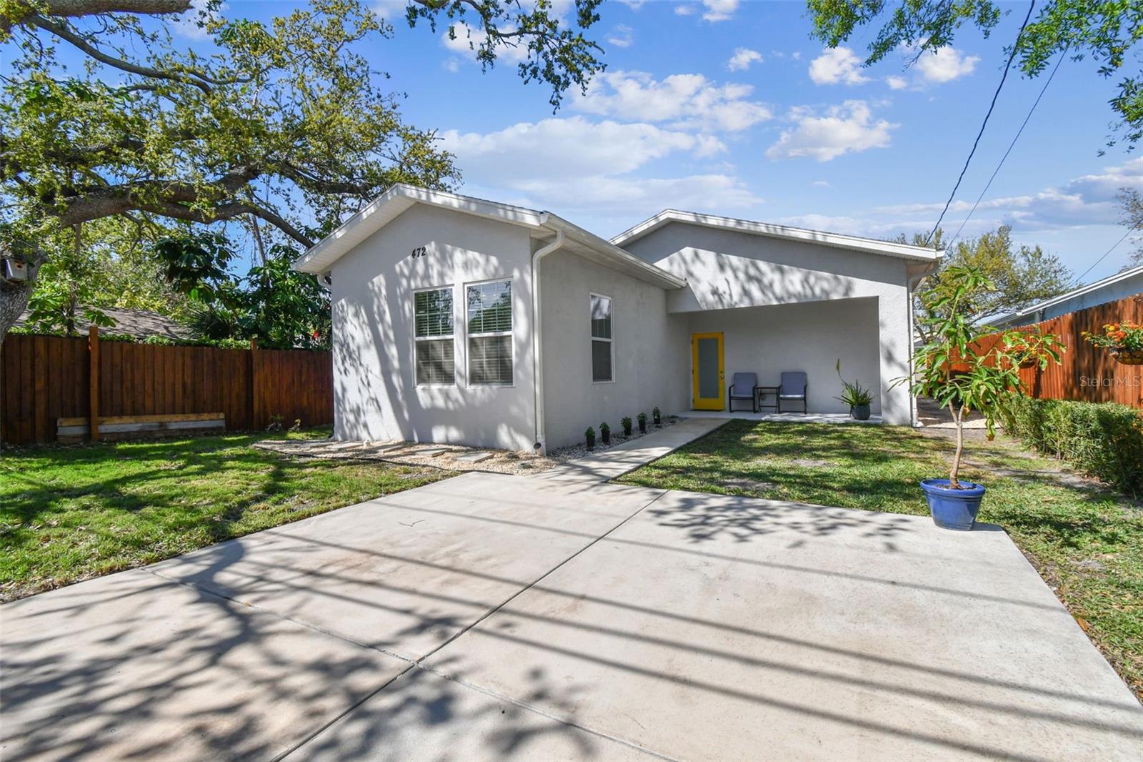 Fenced in back yard with covered porch and parkig pad