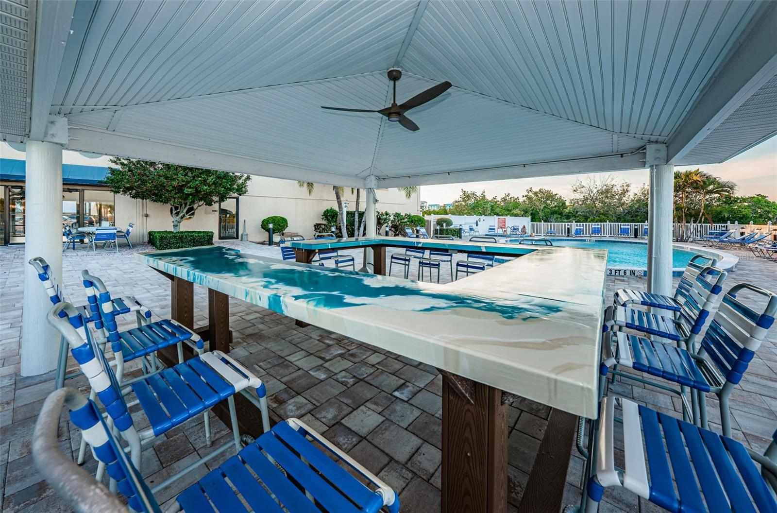 ..Tiki Bar with Clubhouse Entrance on Left and Waterfront Heated Pool & Hot Tub on Right.