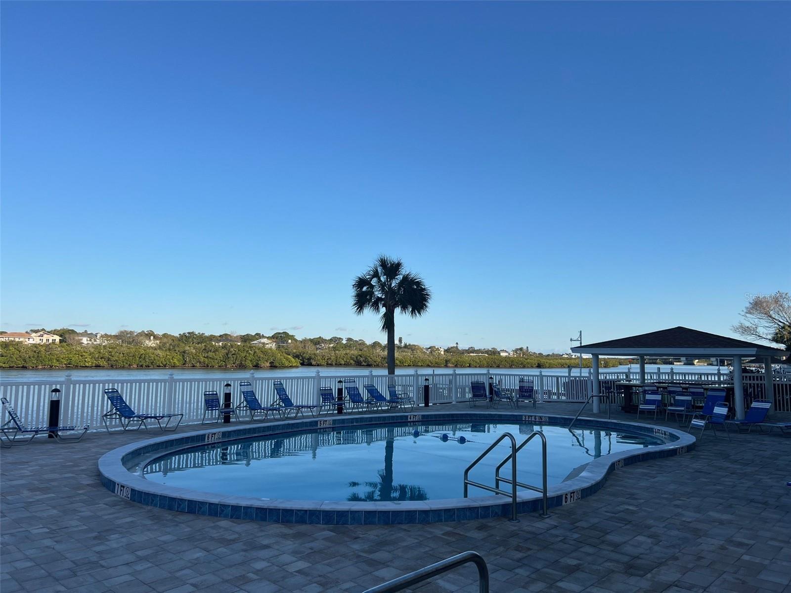 .. Waterfront Heated Pool Looking Back Towards Tiki Hut. .. Wonderful Resort Like Complex Great Amenities.. Fantastic Family Getaway or Winter Retreat. Renters Love the Area. There  are Literally 25 Eateries within Two Miles in Either Direction. A Good Six in Easy Walking Distance - For Breakfast, Lunch or Dinner.