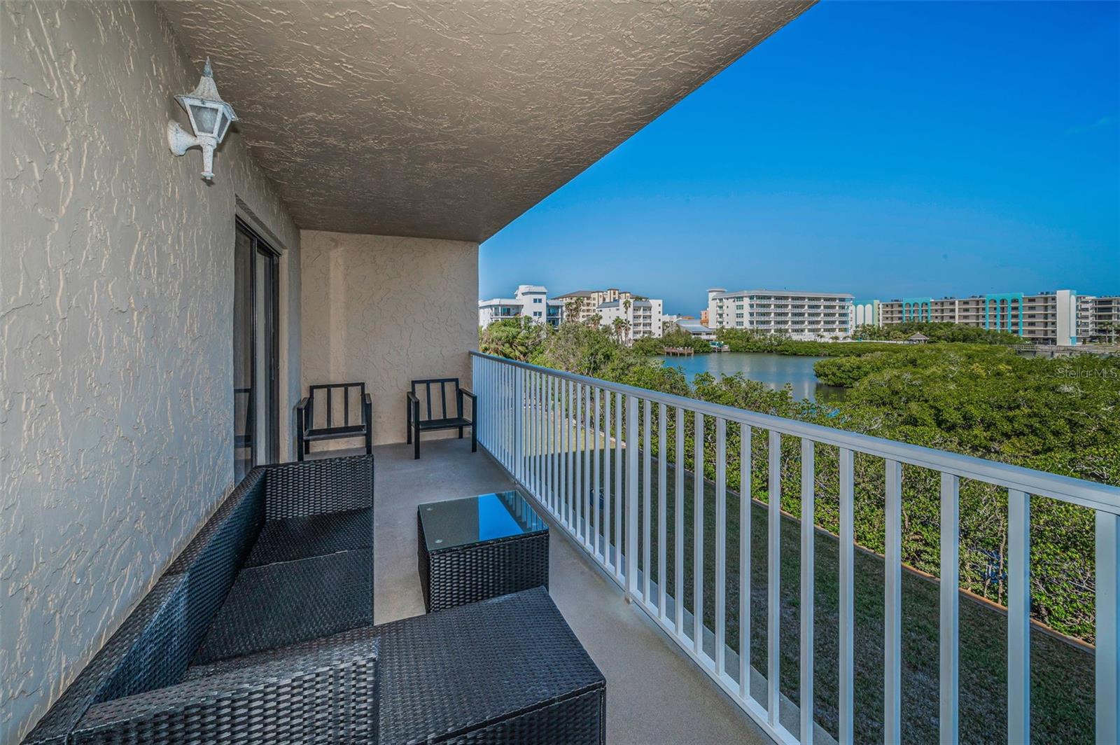 .. Large 24.7 X 6.3 Waterfront Balcony. Manatees & Young Dolphins are Always Playing Near Seawall. Balcony Shot Looking Left. Private Quiet Side of Complex Away From Pool Noise.