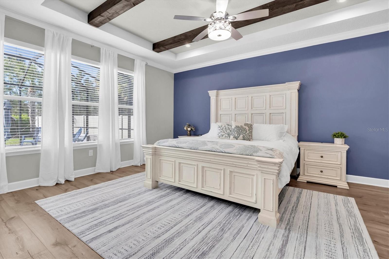 PRIMARY BEDROOM WITH WOOD BEAMS