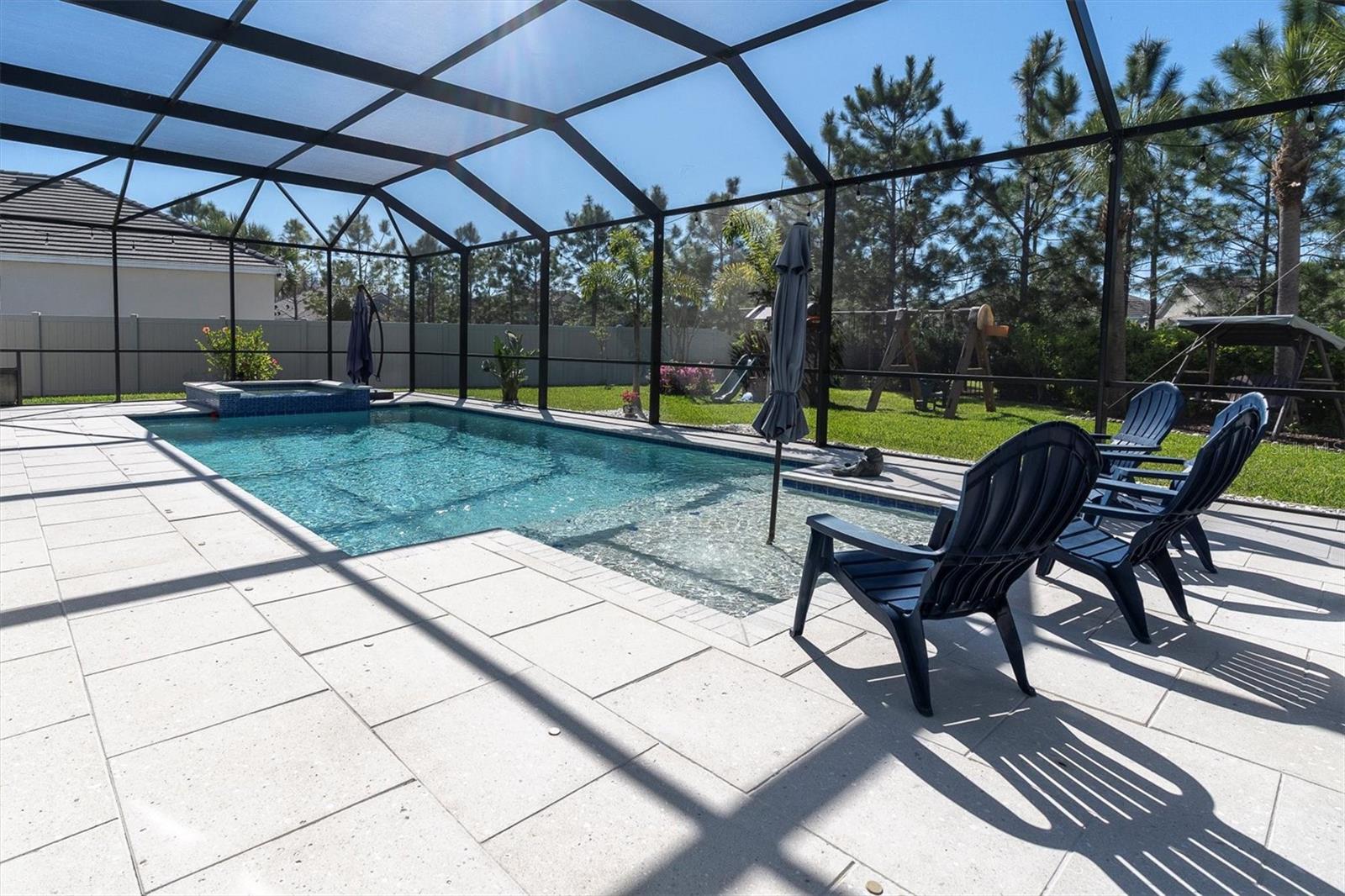 SALTWATER POOL IS HEATED AND SCREENED TO ENJOY ALL YEAR