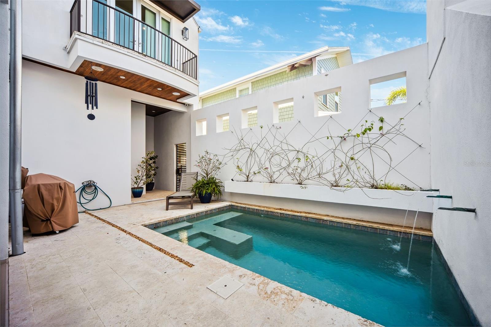 Mediterranean feel to this pool and lounge area.