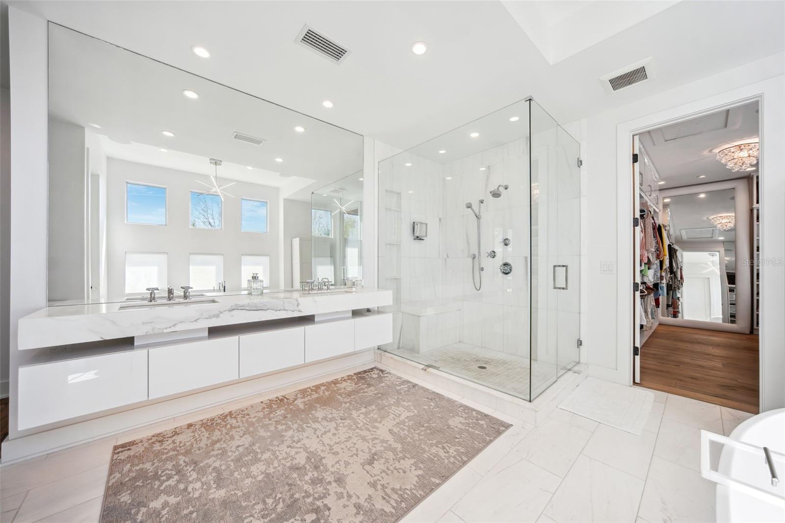 Separate walk-in shower with built-in bench.