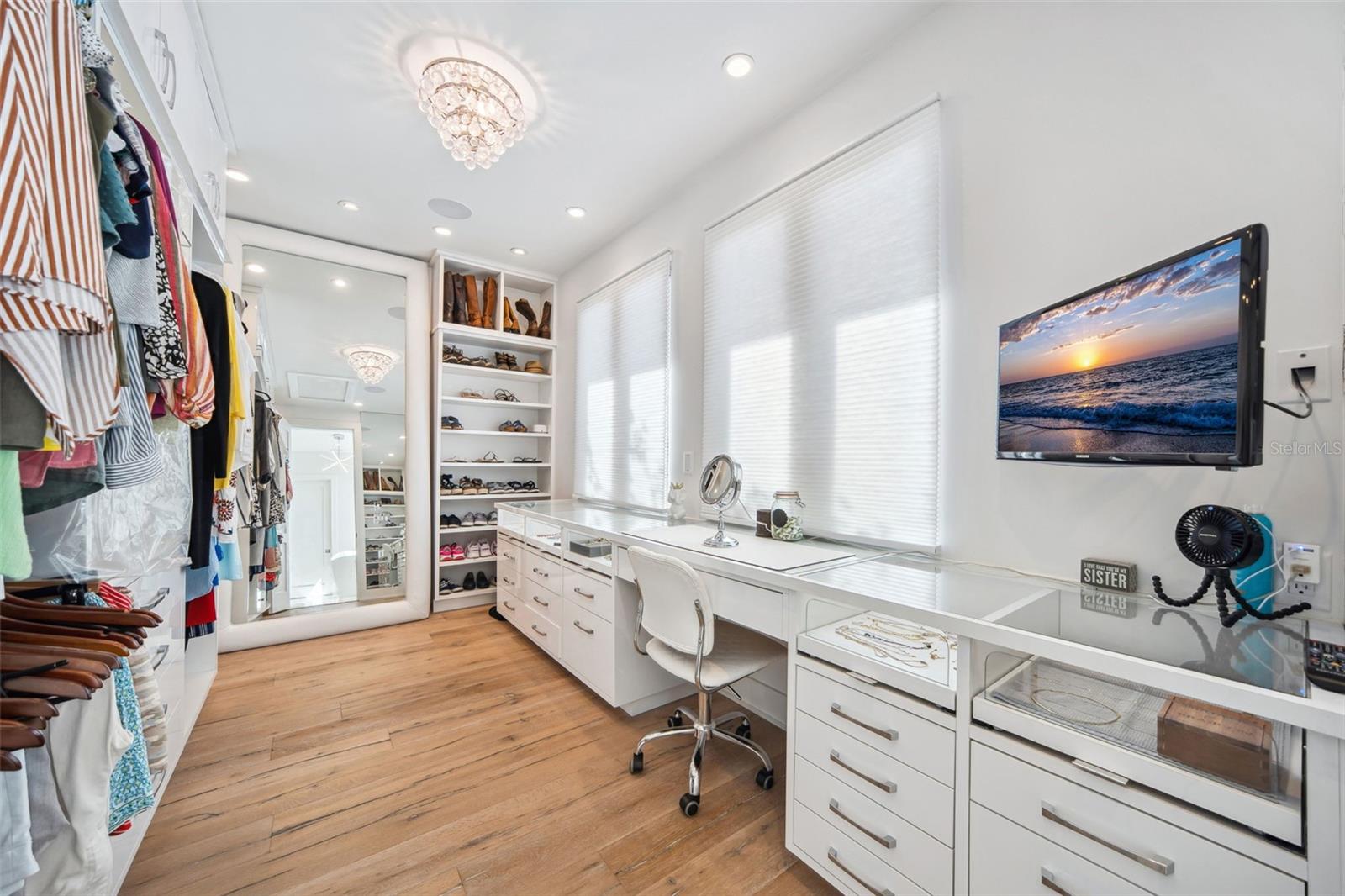 Primary walk-in closet with built-in makeup vanity.