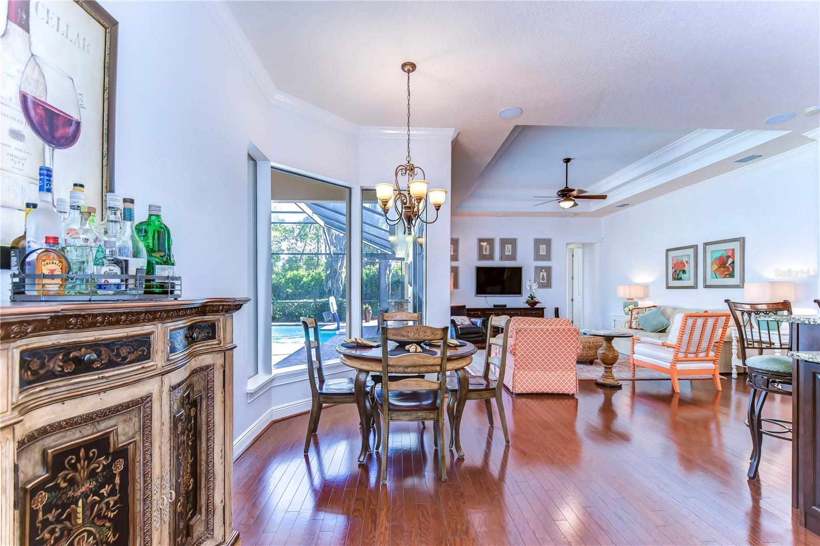 The seamless flow of the hardwood floors guides you from a cozy dining area to an inviting living space, perfect for entertaining guests.