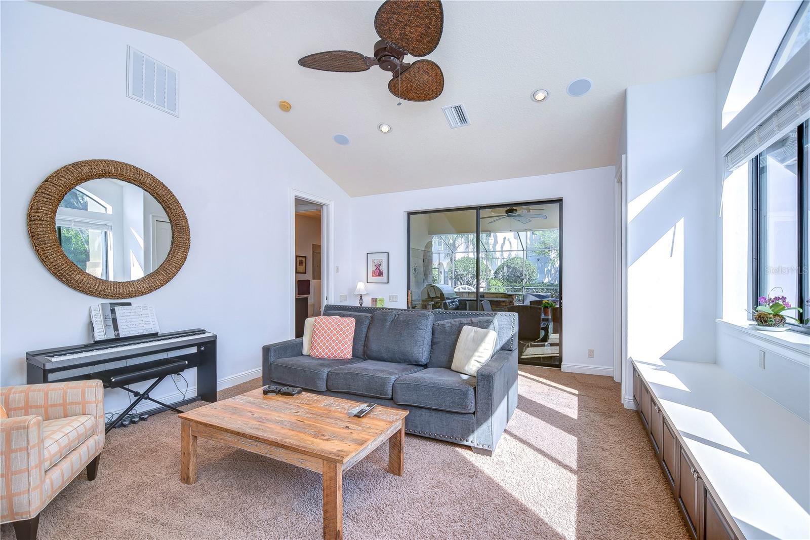 Step into this inviting space bathed in natural light, defined by its vaulted ceilings and ample natural lighting.