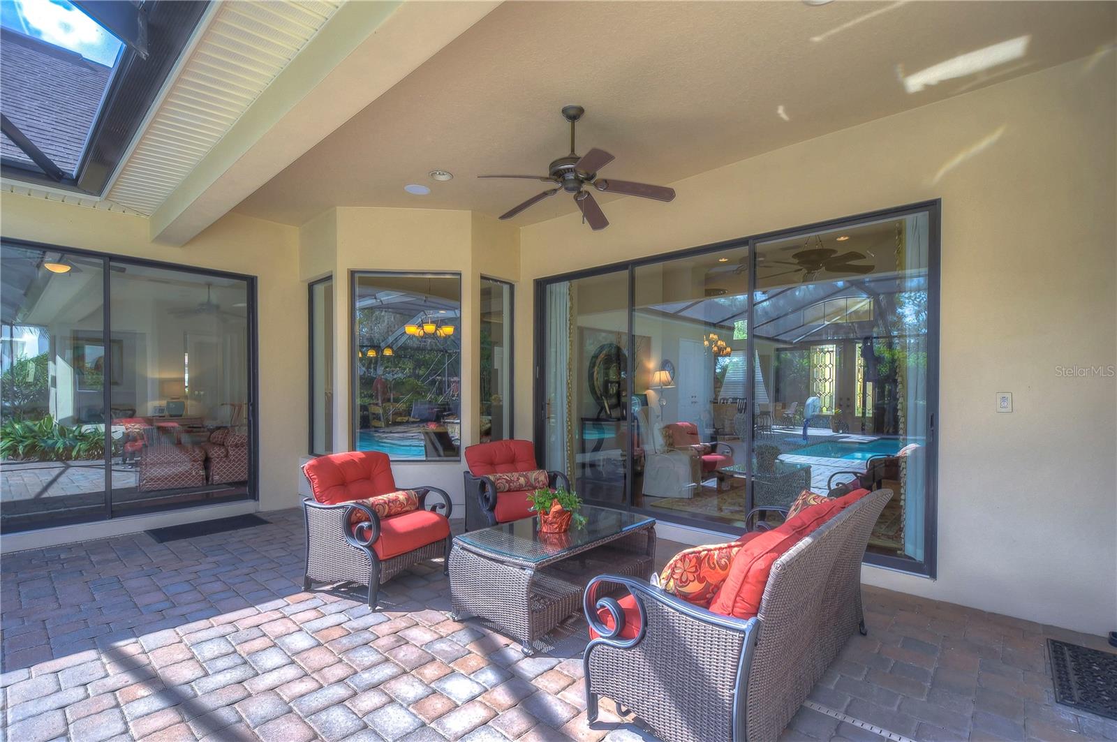 This inviting outdoor space offers direct access to a sparkling pool, perfect for both relaxation and lively gatherings.