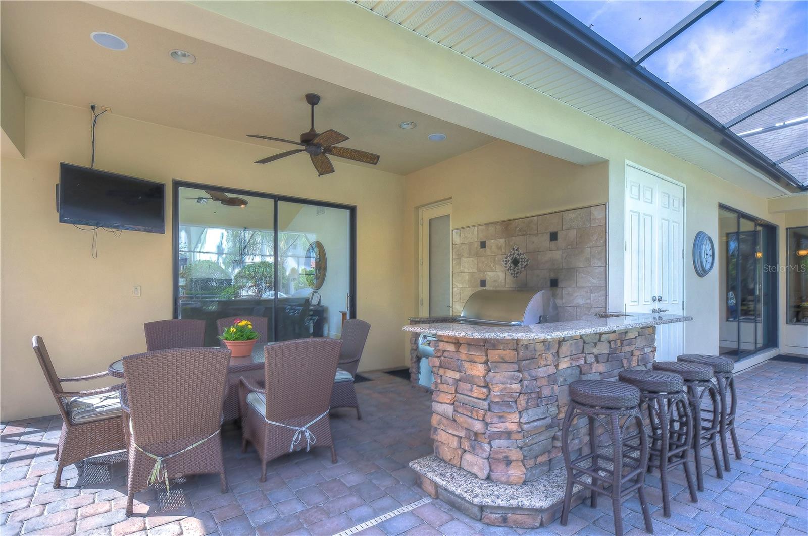 Enjoy alfresco dining under the ceiling fan’s gentle breeze, surrounded by elegant comfort and modern convenience.