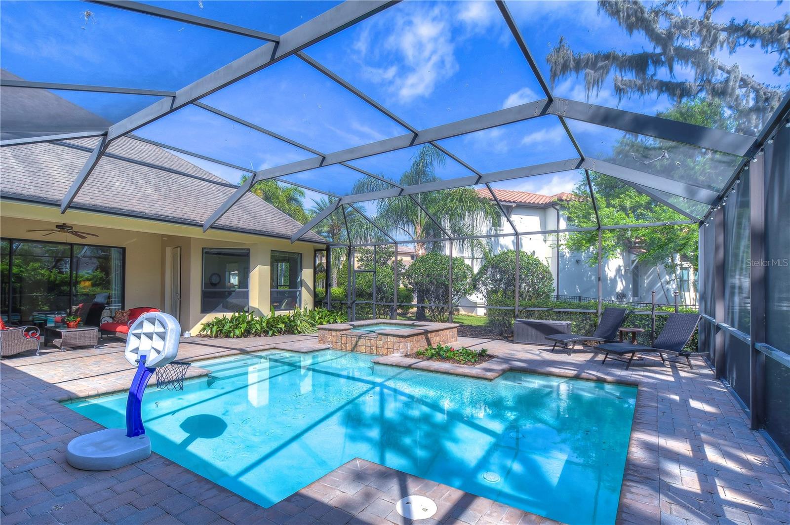 Dive into paradise with this spacious screened-in pool area, perfect for lazy afternoons and weekend gatherings.