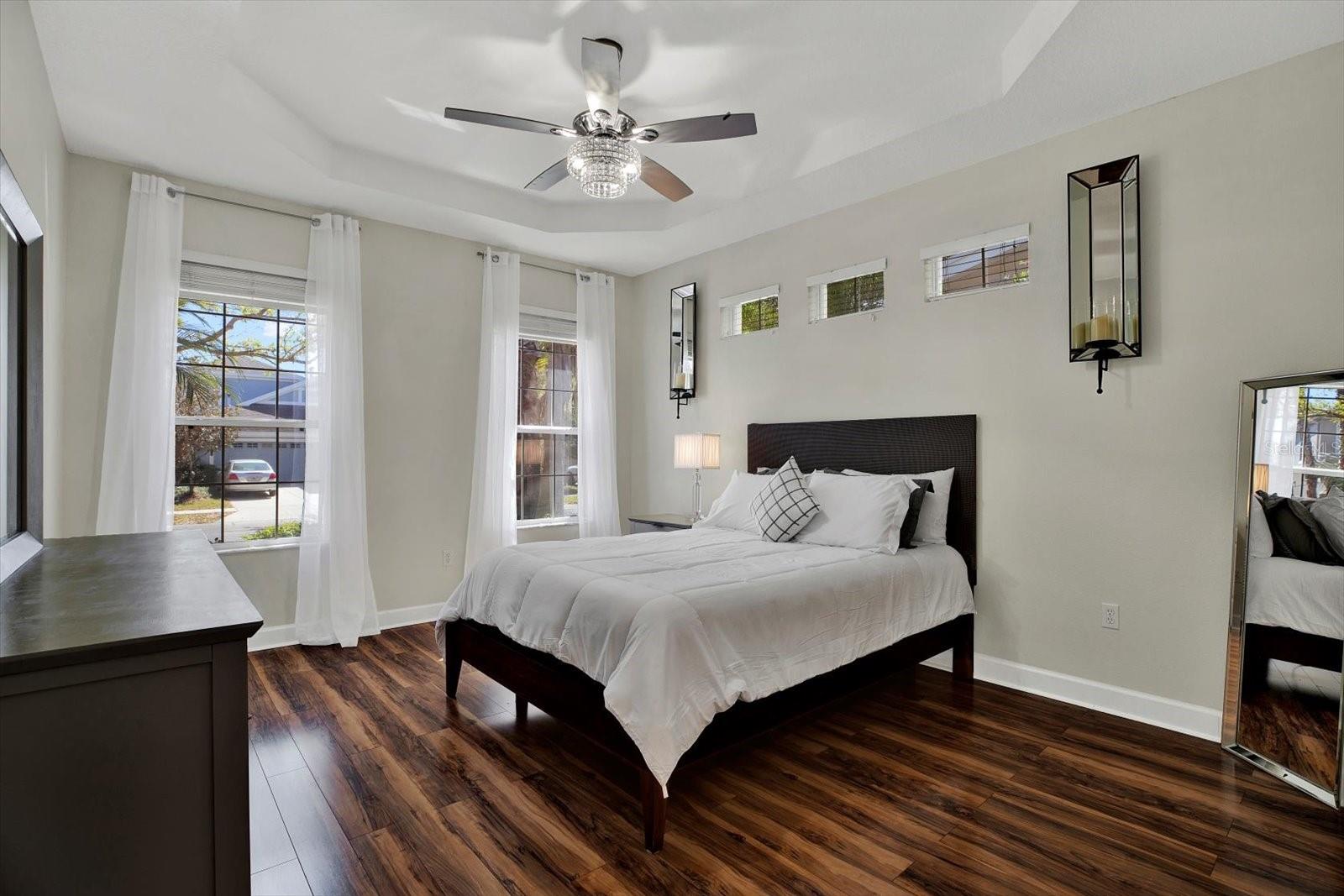 Primary bedroom: check out the gorgeous light fixture/fan!