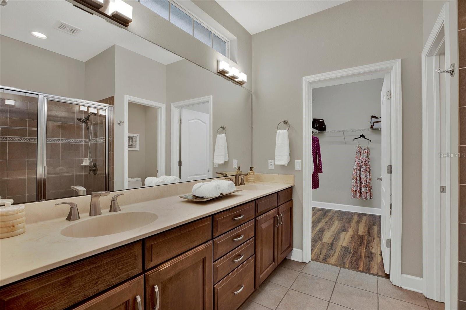 Ensuite bathroom features dual sinks and 3 closets