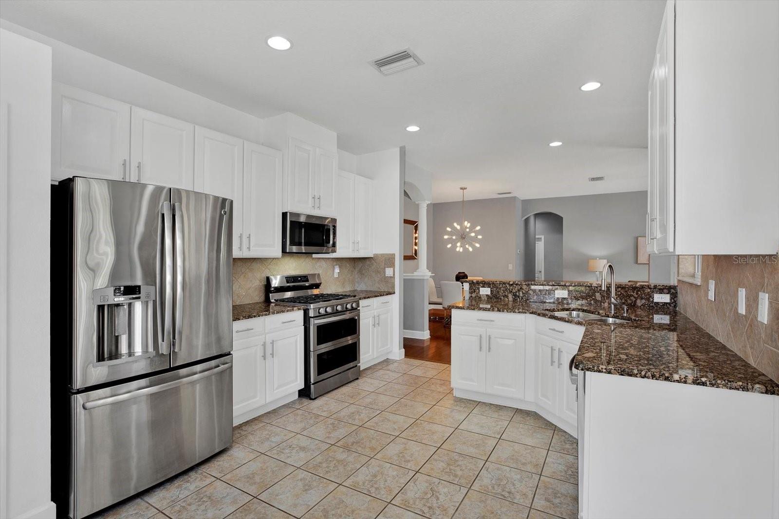 Stainless appliances include french door refrigerator and gas range