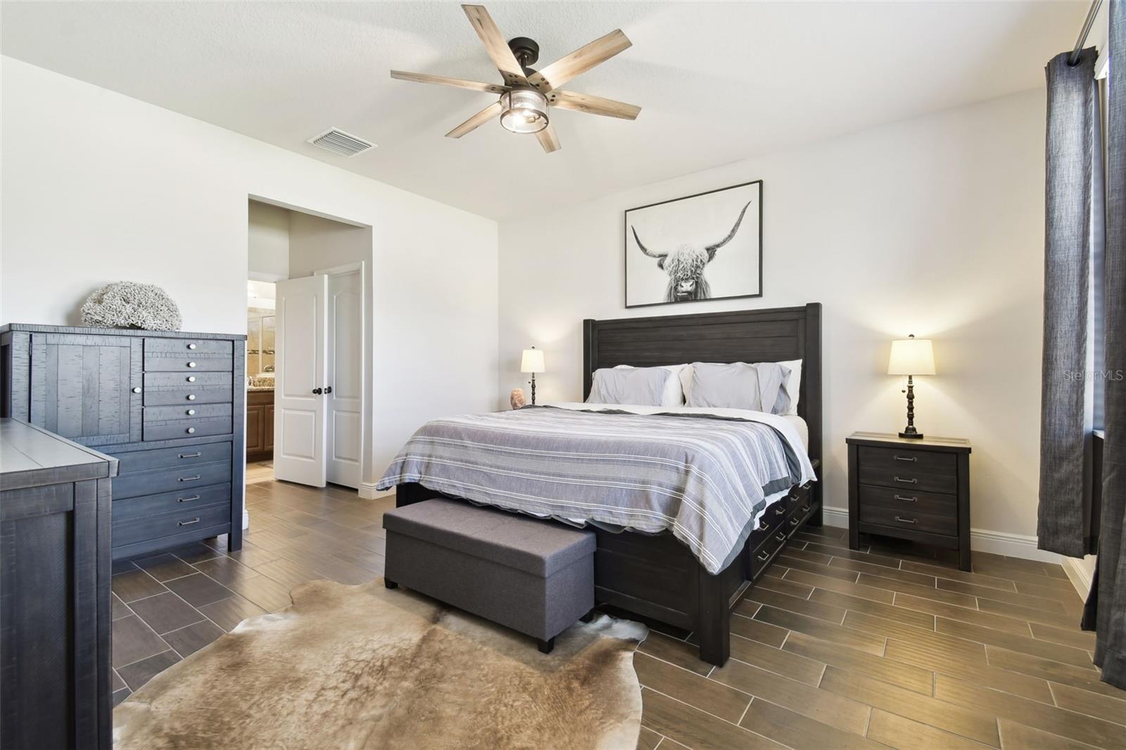 Primary Bedroom w/ wood look tile floors