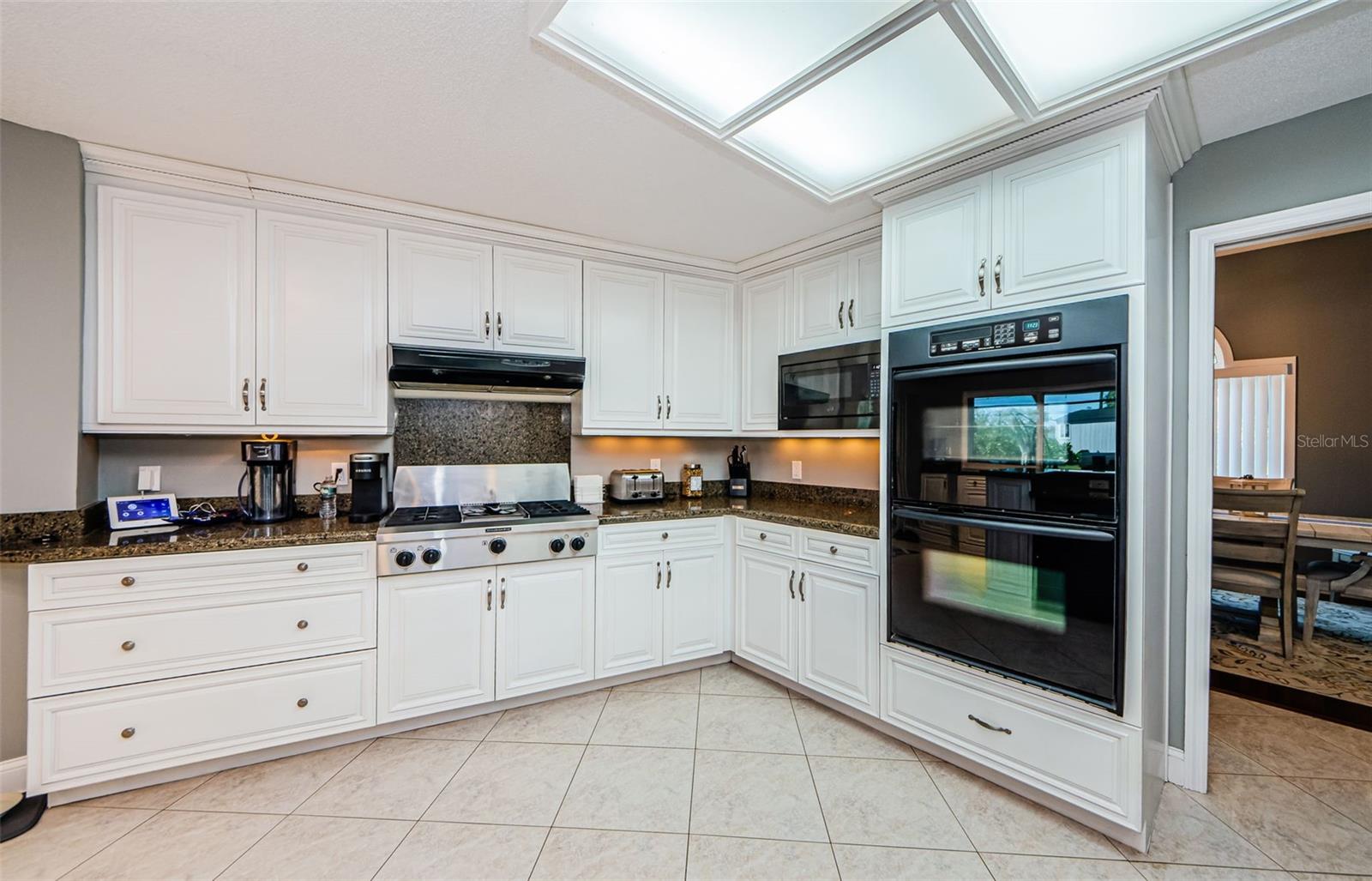 Double oven, one convection, microwave oven, cooktop with extensive exhaust system.