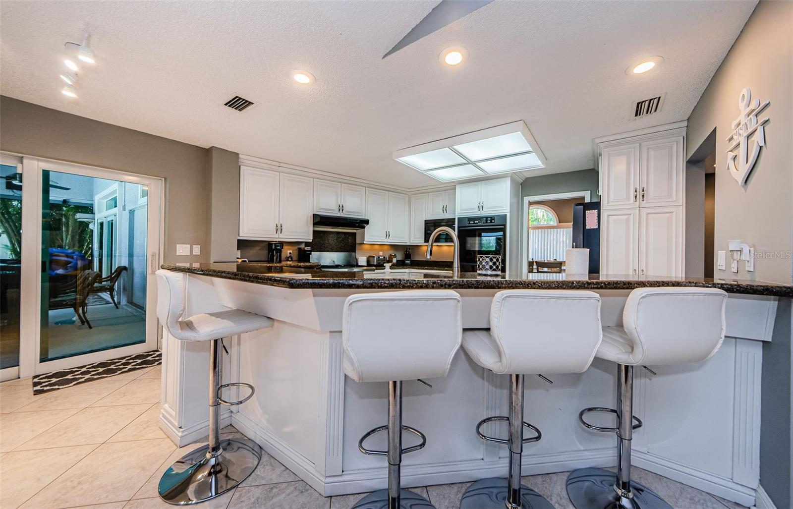 Bar stools at kitchen breakfast area.