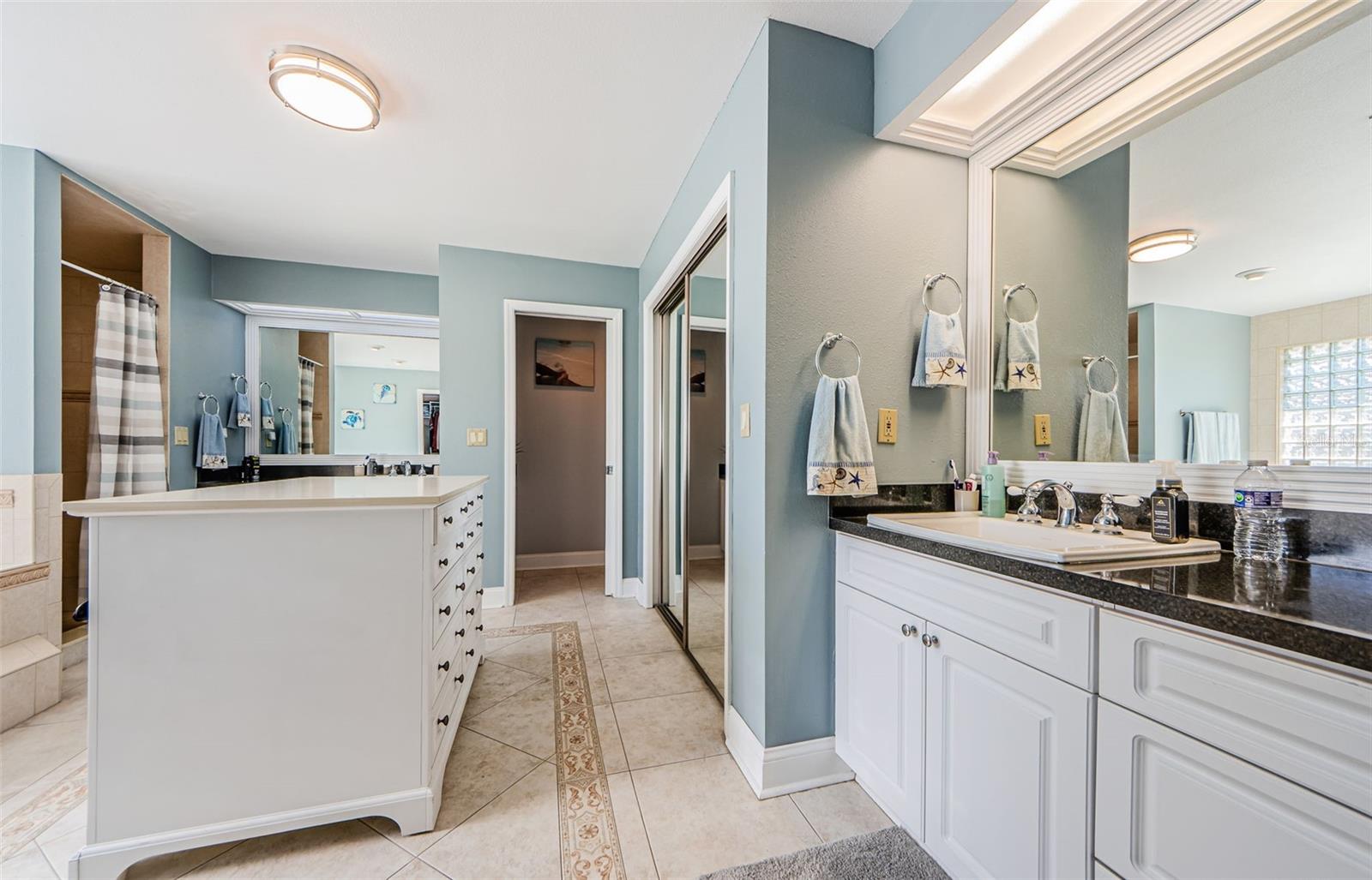 Primary Bathroom, with his and hers closets, shower and separate garden tub.