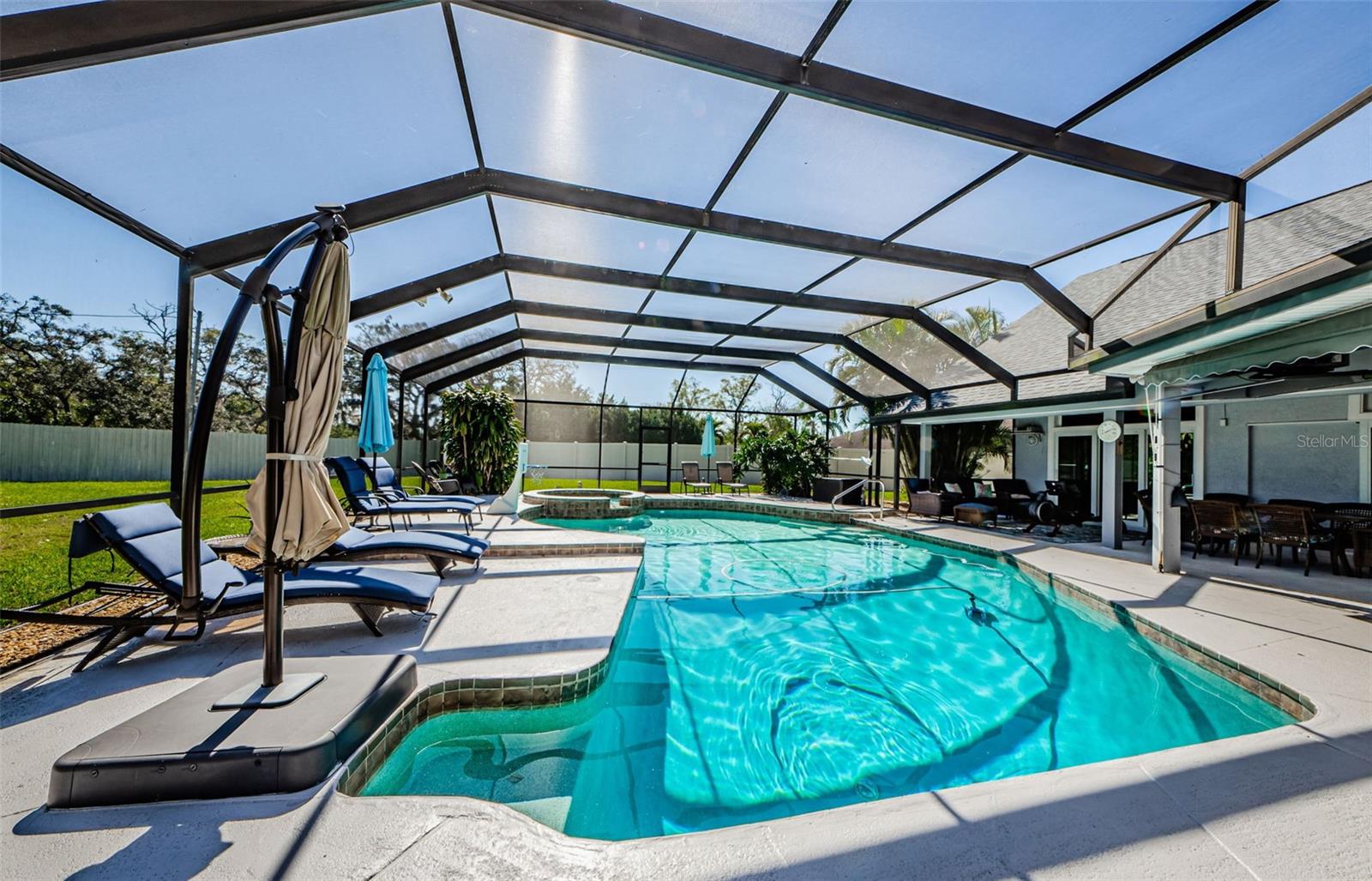 Long view of pool and spa at the end; under roof pavilion to the right.  Another day in paradise!