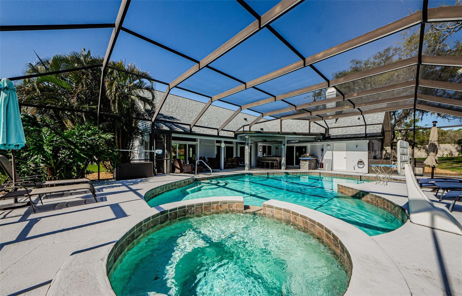 Lovely backyard scene of the heated pool and spa with crystal clear water with the sky as blue as it can be.  Just doesn't get any better!