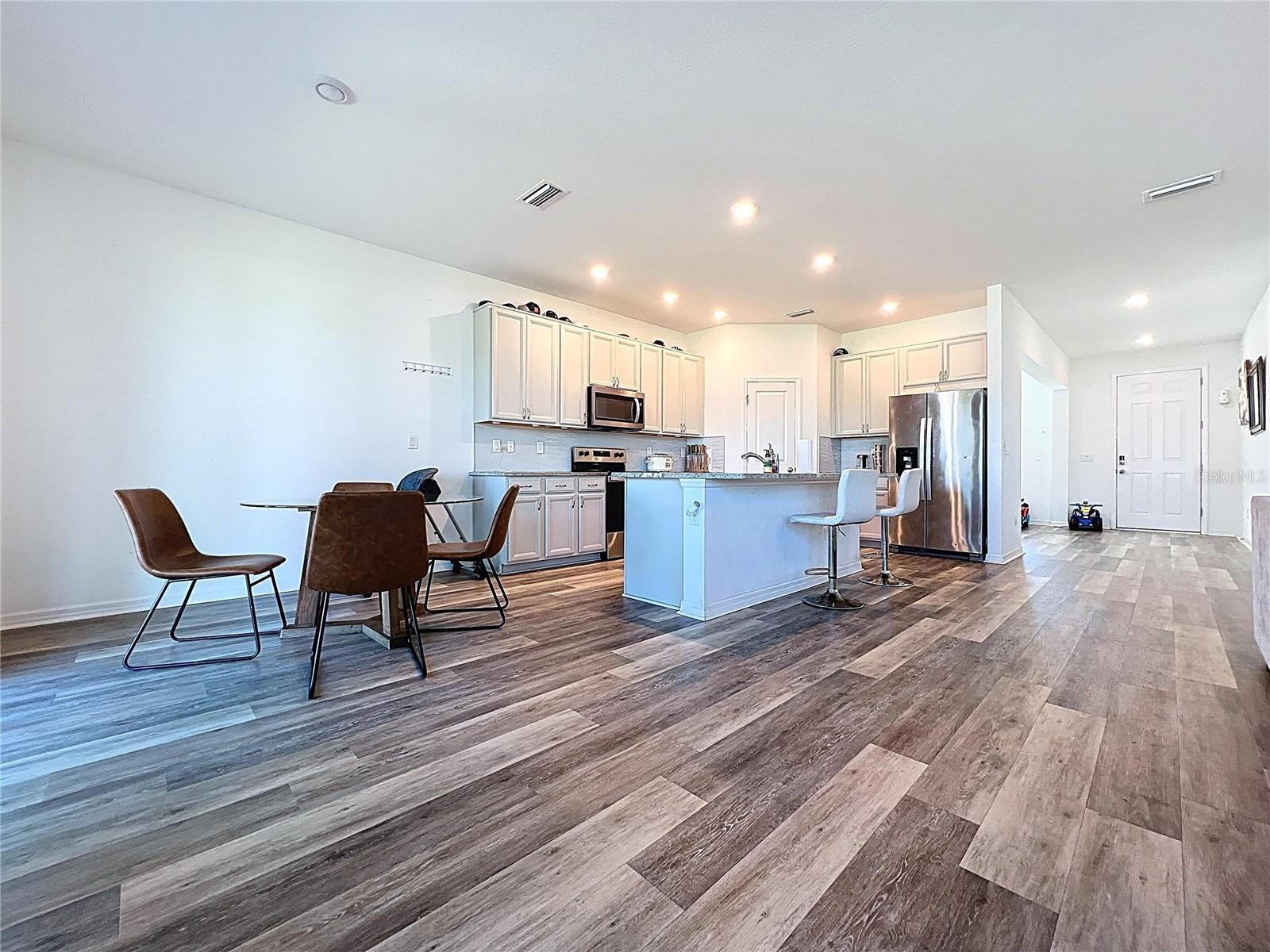 Looking from back of family room to front door through kitchen