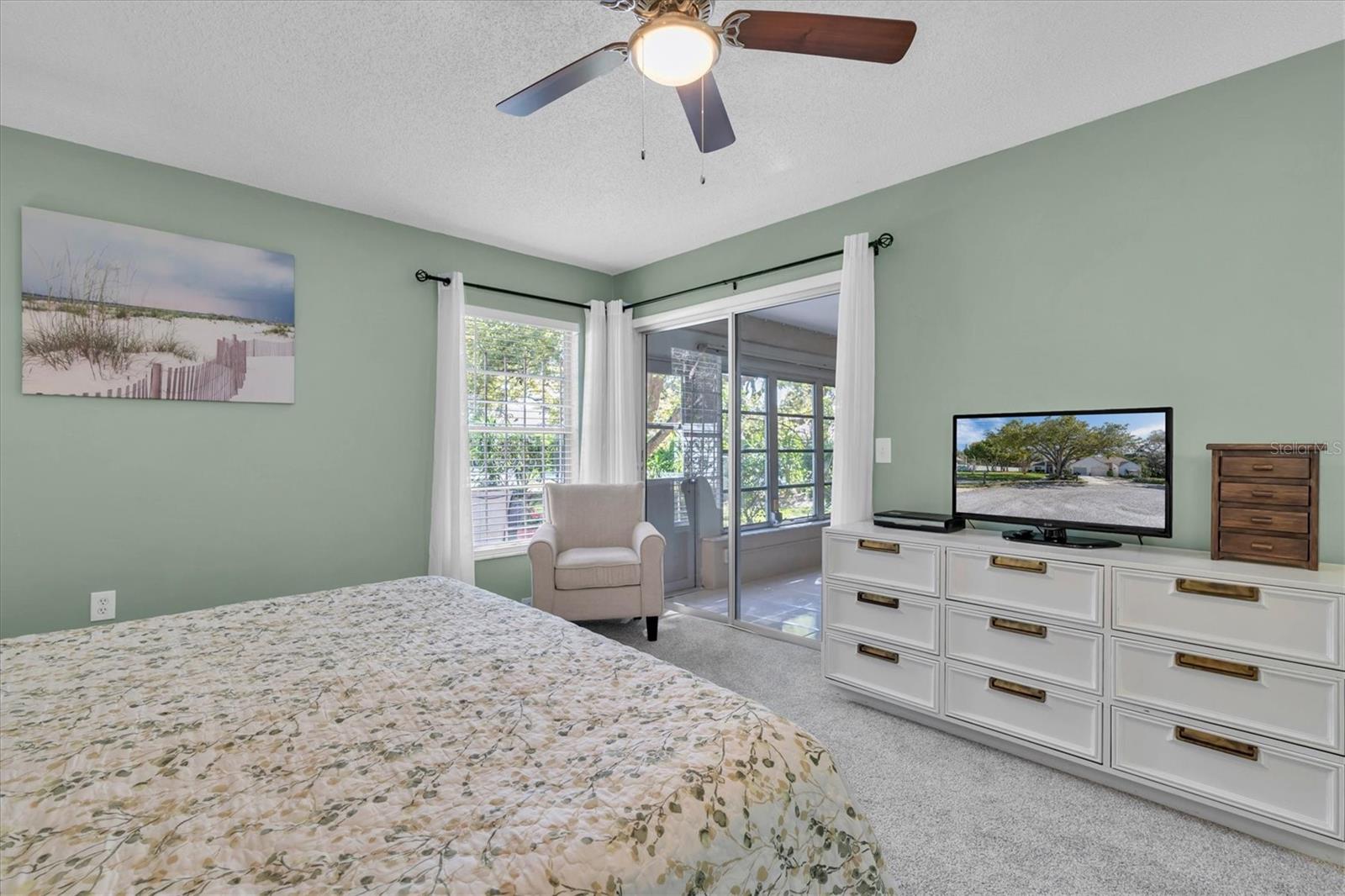 Primary bedroom with sliding doors to Florida room