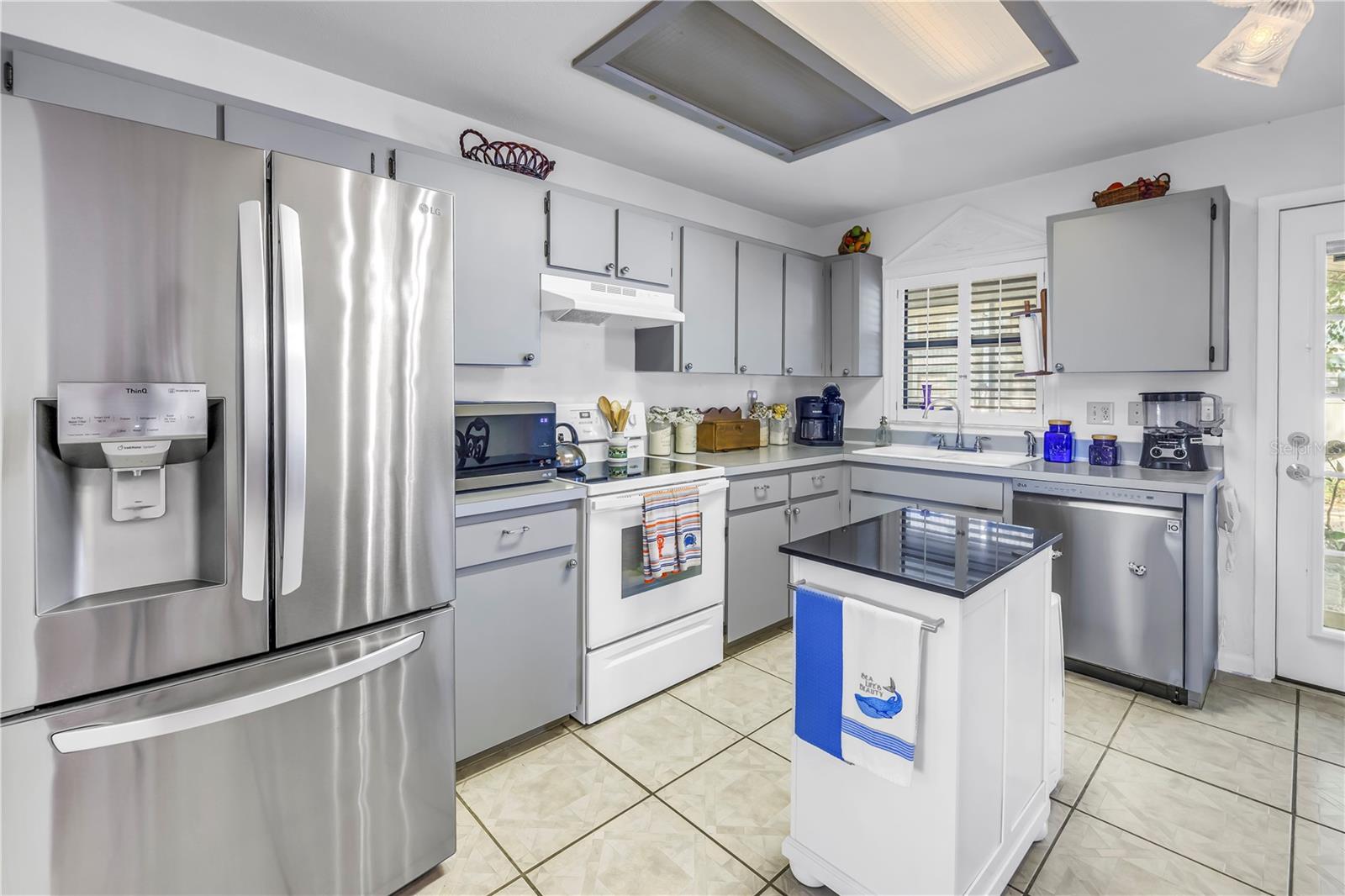 Great Kitchen with newer stainless Refrigerator and Dishwasher.  Plenty of workspace, including Island