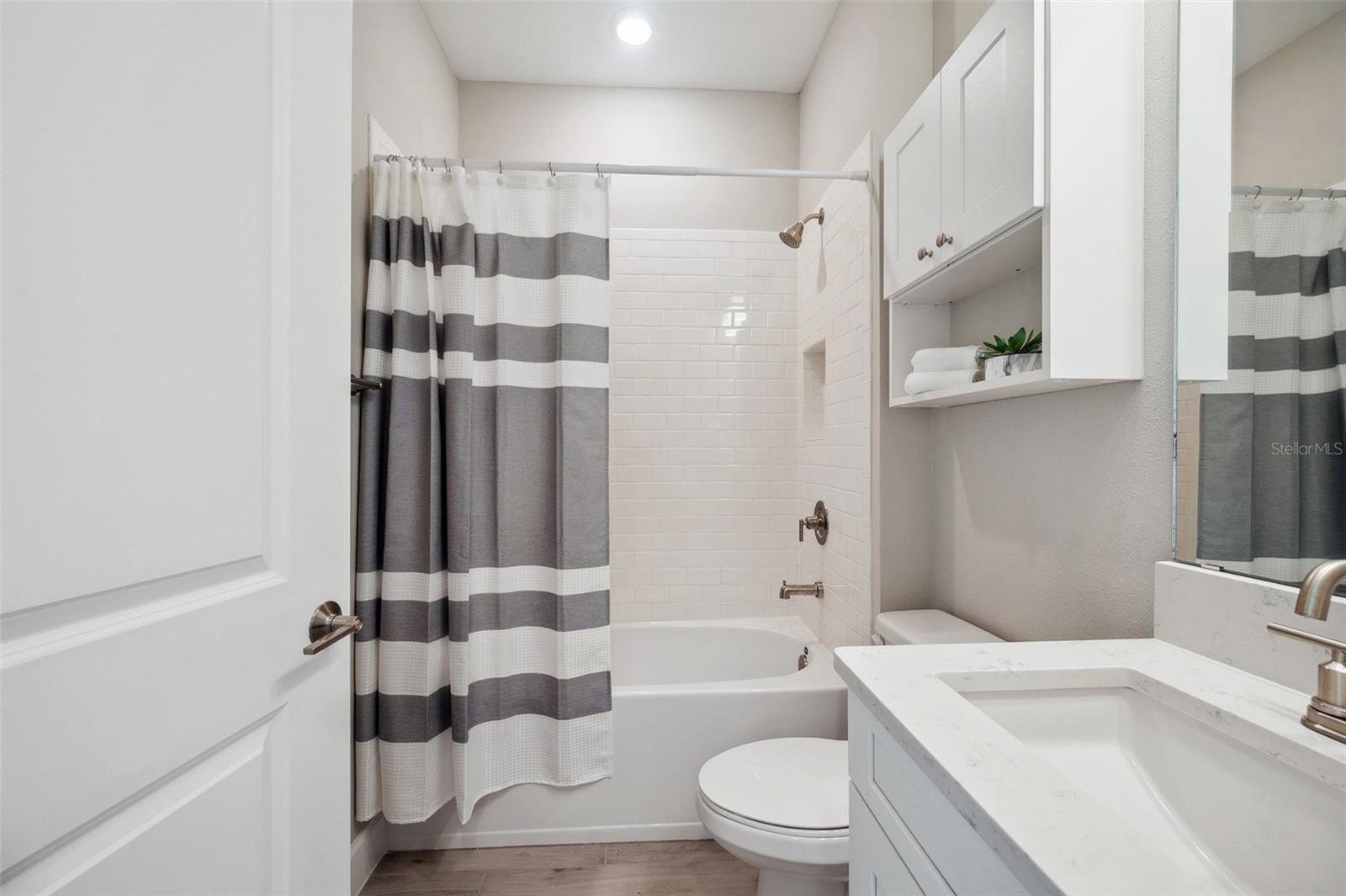 Bathroom 3 with Full Bath Quartz Counter Tops on Vanity & Subway Wall Tile