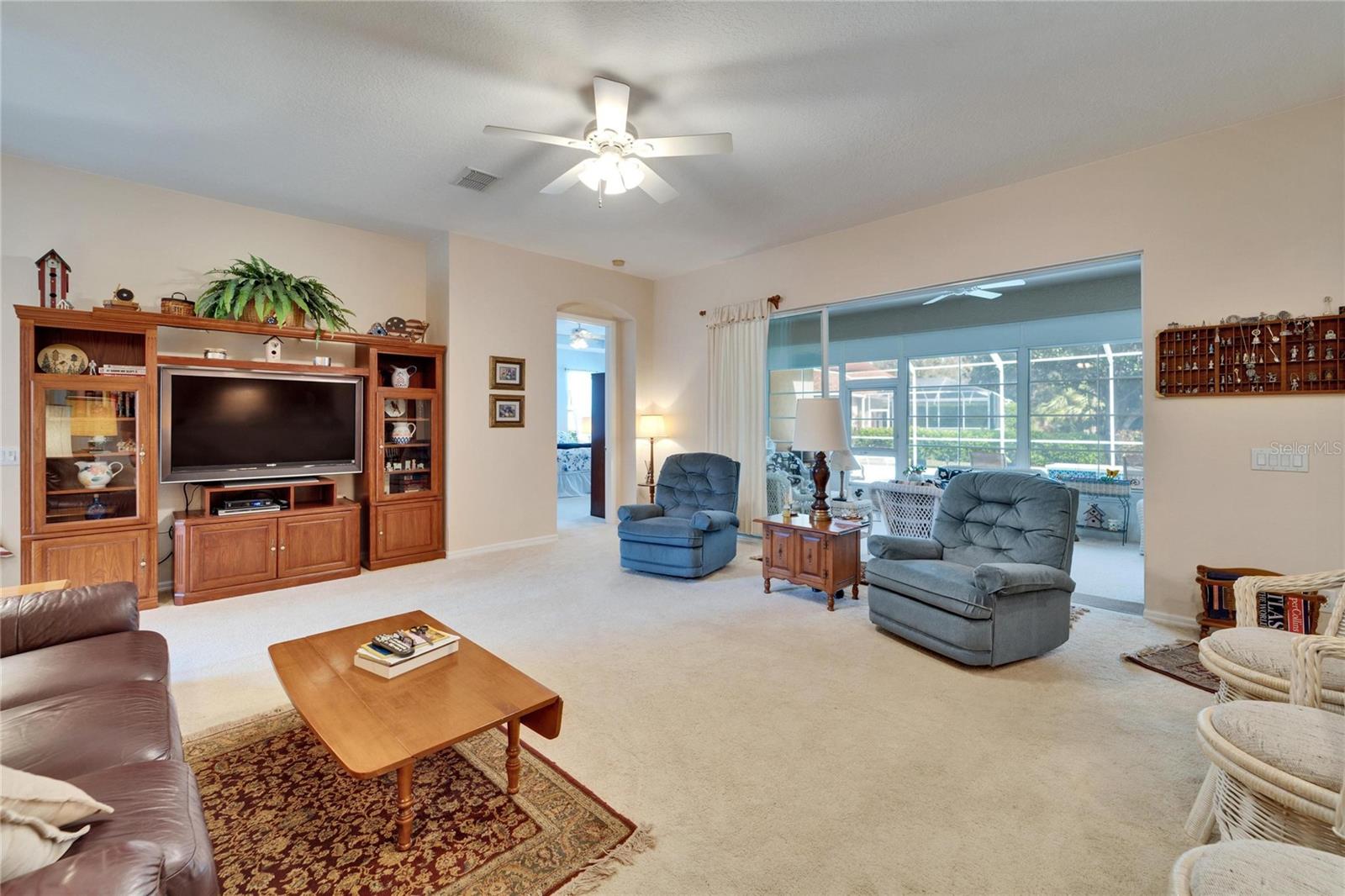 Family room with sliding glass doors that leads to an enclosed porch.